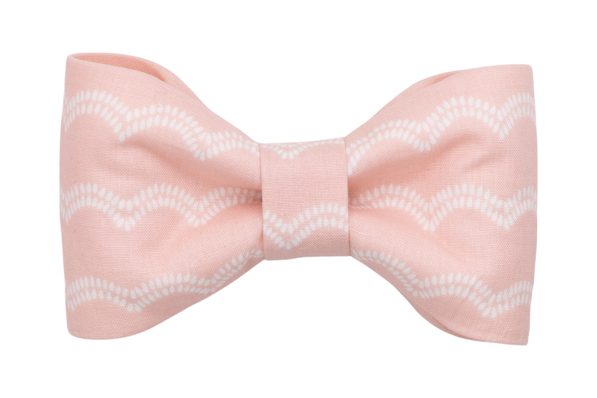 Light blush pink handmade dog bow tie featuring a simple and modern design of white scalloped lines across the fabric, giving it a coastal feel.