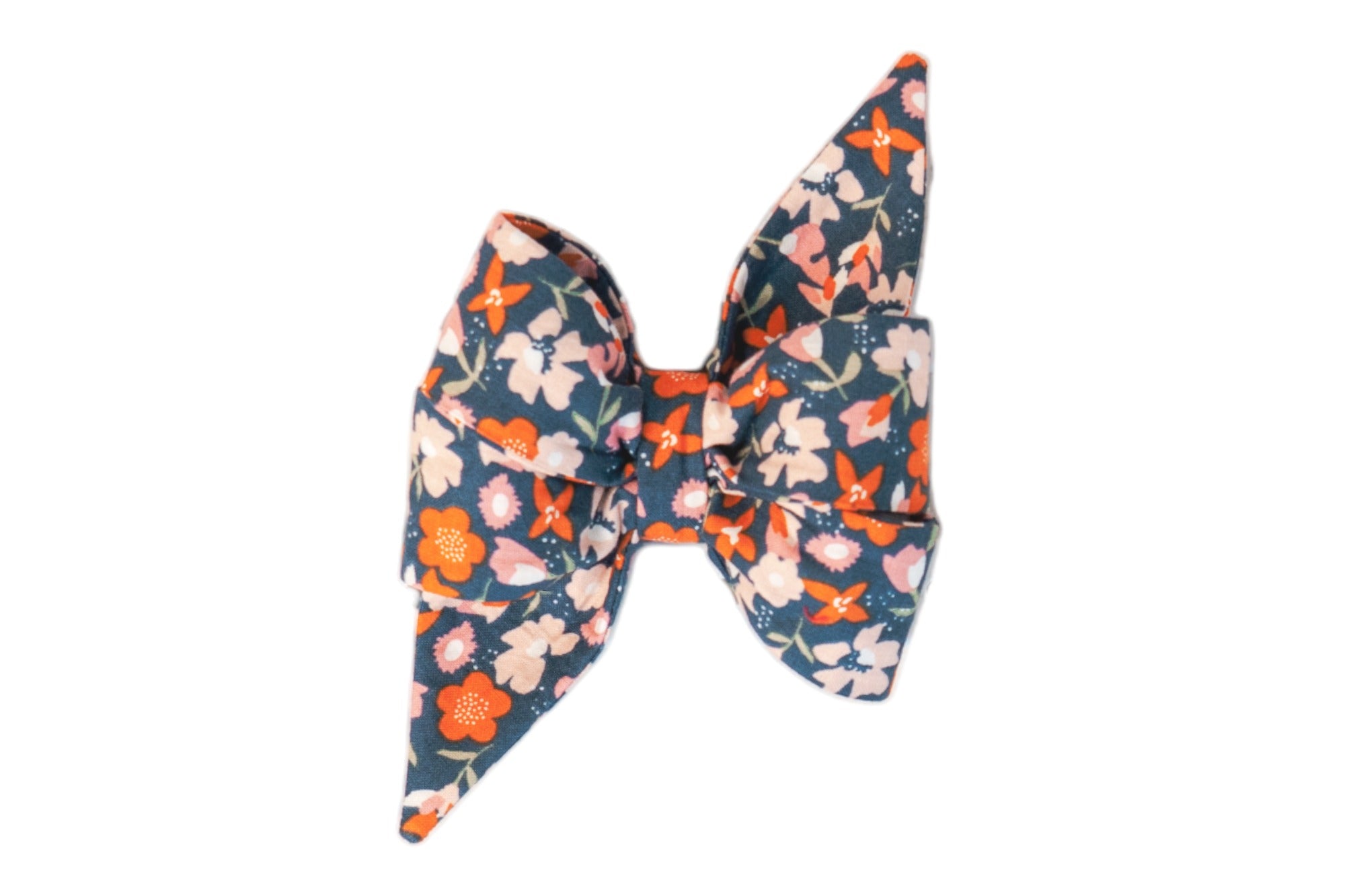 Charming Fall inspired girl dog belle bow with a floral pattern in vibrant coral, blush, and ivory against a deep teal background.