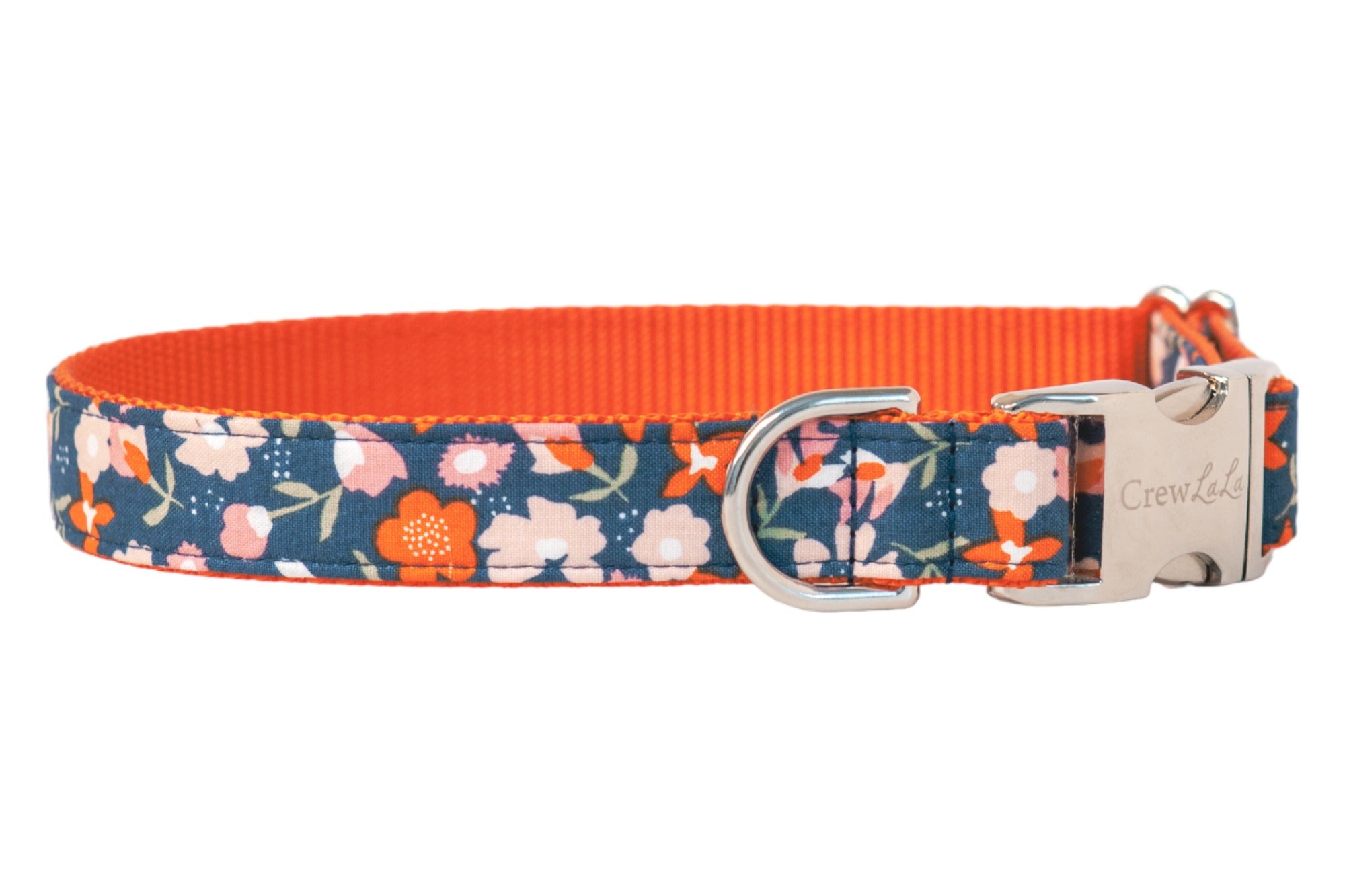 Stylish dog collar featuring a navy base with a colorful floral design of flowers connected by leafy stems. The outer fabric is sewn over durable nylon webbing, with neat stitching along the edges, and is completed with polished hardware for fastening and leash connection.