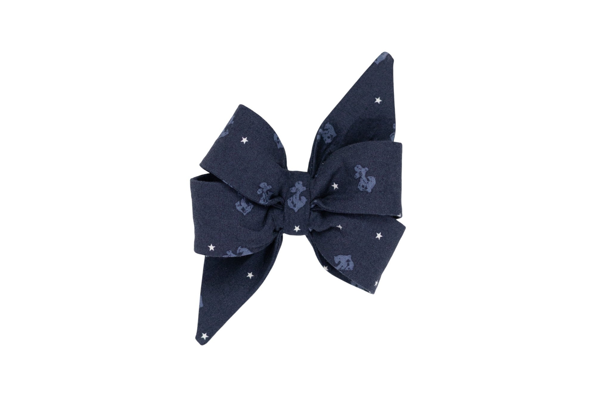 Navy blue girl dog belle bow decorated with light blue anchors and white stars. Perfect for pups who live on the coast or that have a nautical flair.
