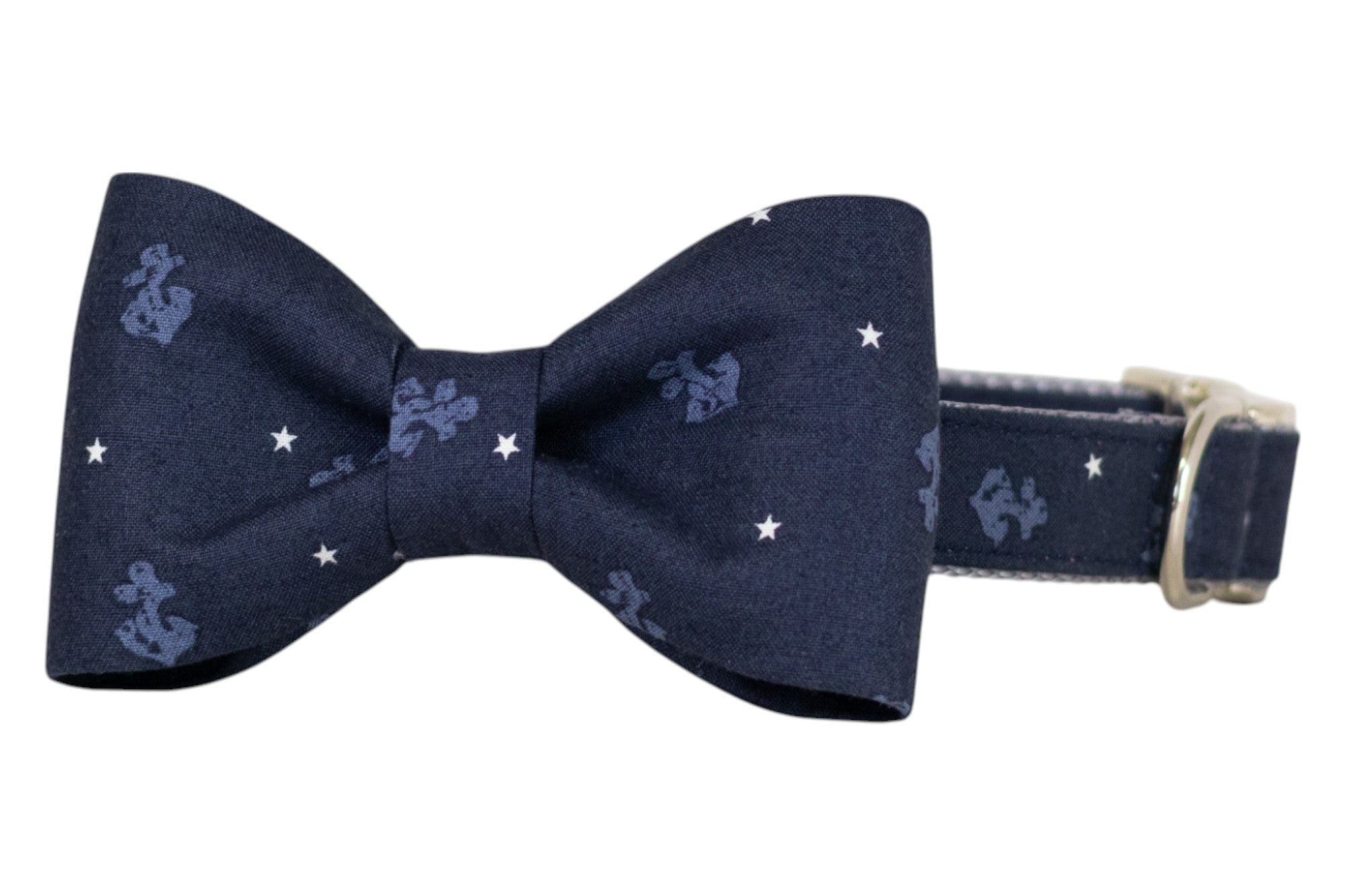 Navy blue dog collar with a matching classic bow tie, featuring light blue anchor designs and white stars. The collar is adjustable and includes a silver metal buckle for secure fastening.