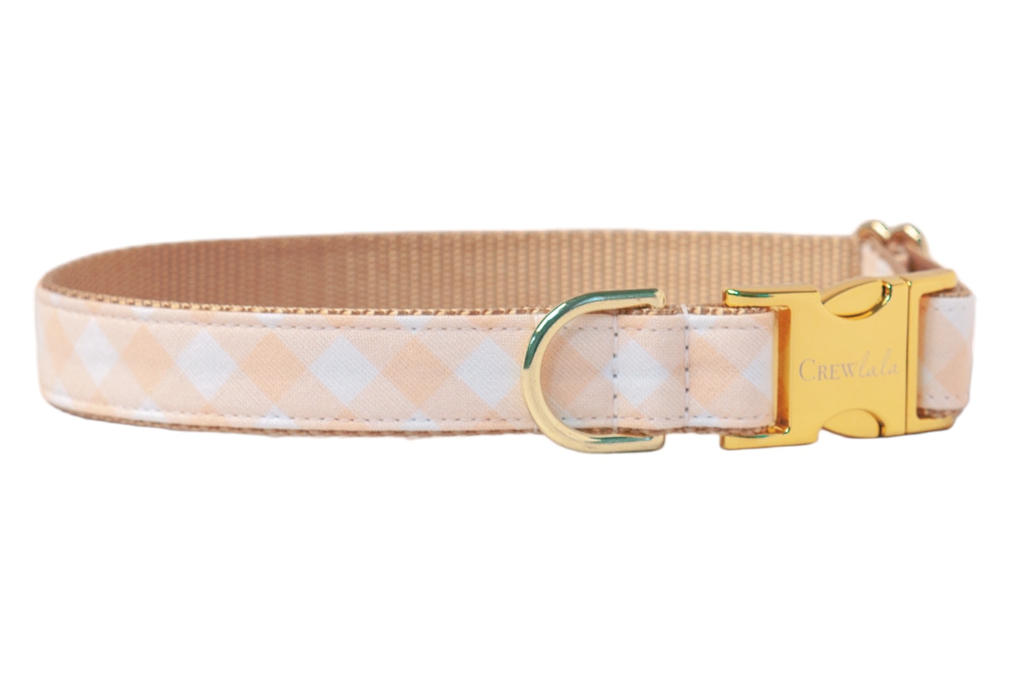 Apricot and white checkered dog collar with reinforced stitching, tan nylon webbing on the inside for comfort, and elegant gold hardware including a branded “Crewlala” clasp and leash D-ring—designed for dogs with classic charm.