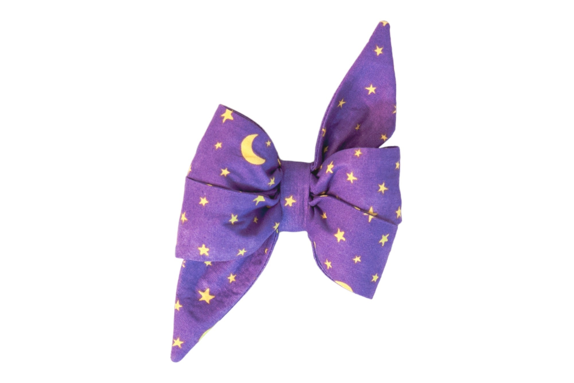 A large dog belle bow made of purple fabric with a pattern of stars and crescent moons. The belle bow features layered loops and two long, pointed tails for a dramatic look. A festive and enchanting accessory, perfect for Halloween, costume parties, or celestial-themed events.