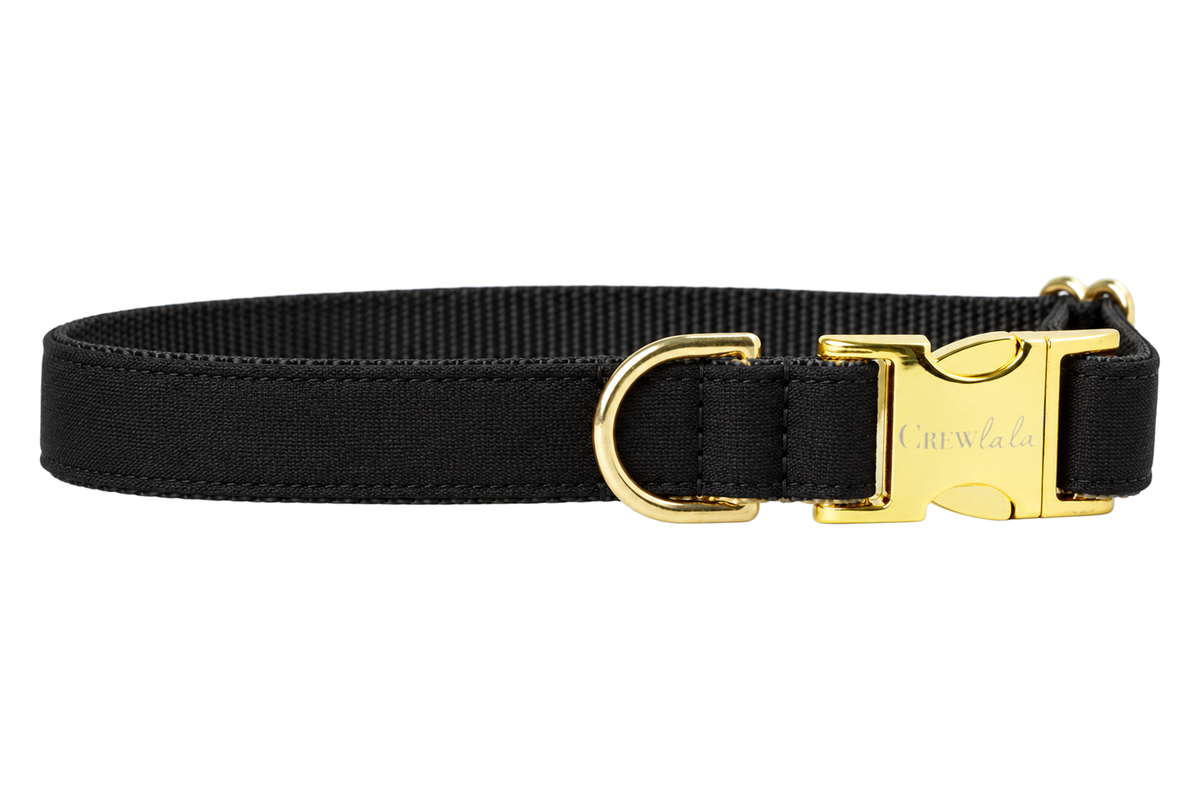 Plain Black Tie Woven dog collar without the bow, made with a solid black woven fabric with a subtle texture, lined with black nylon webbing and gold hardware with a Crewlala logo buckle.