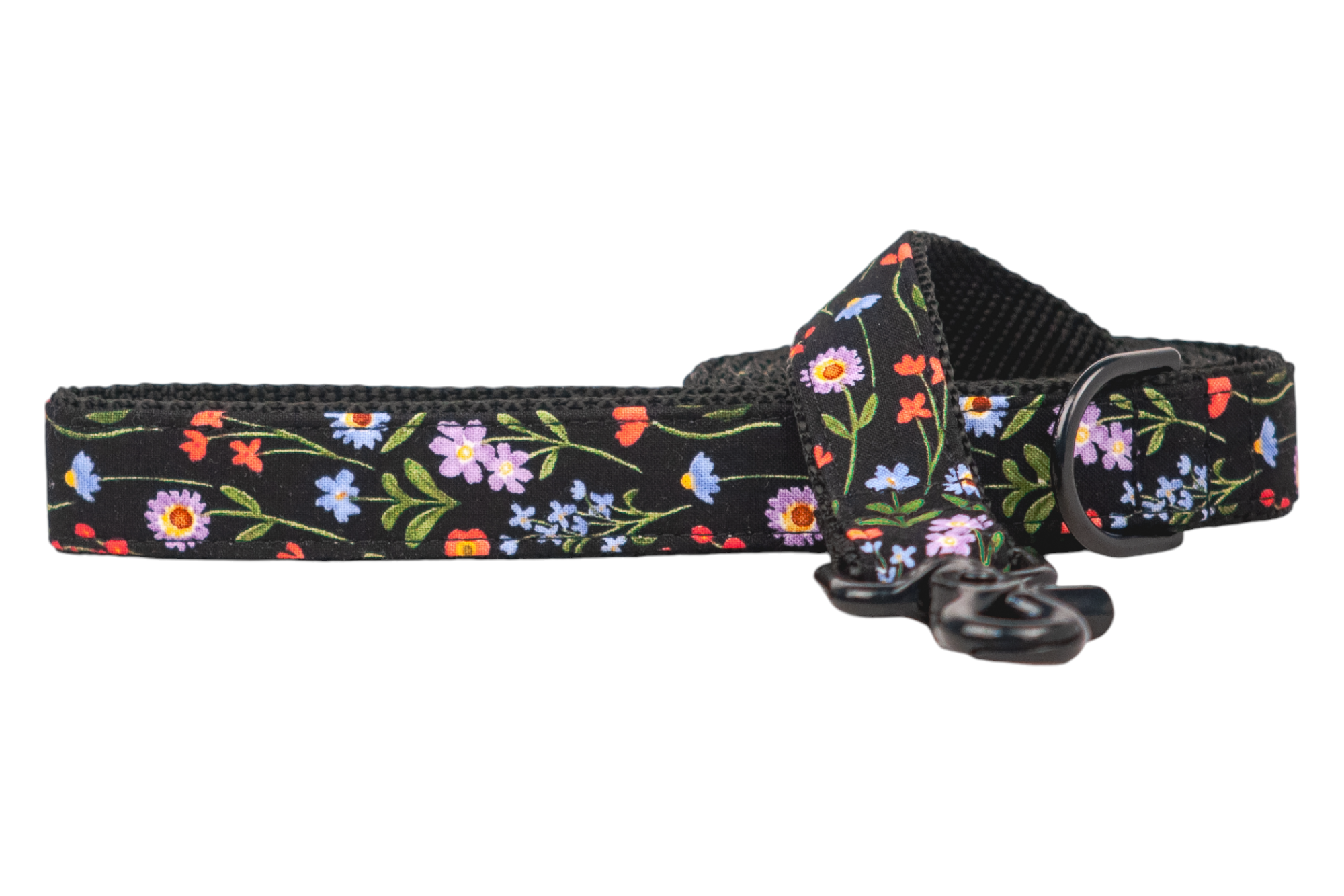 Stylish black dog leash adorned with a vibrant wildflower print. The leash has a soft woven nylon lining on the inner side, a reinforced handle, and a durable black metal swivel clip for easy connection.