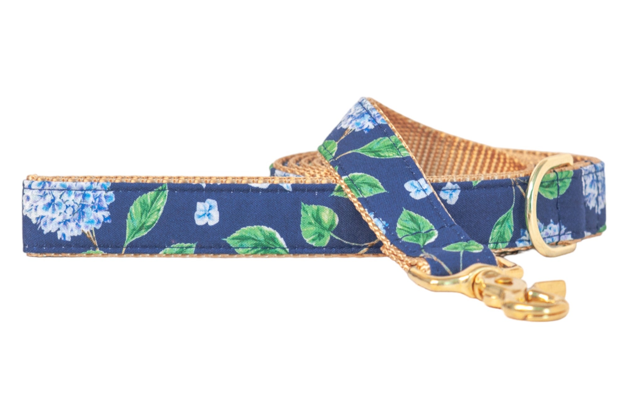 A stylish dog leash with a dark blue floral print showcasing hydrangeas and leafy stems. The underside is nylon webbing for durability, and the leash is finished with shiny metal hardware, including a clasp and D-ring.