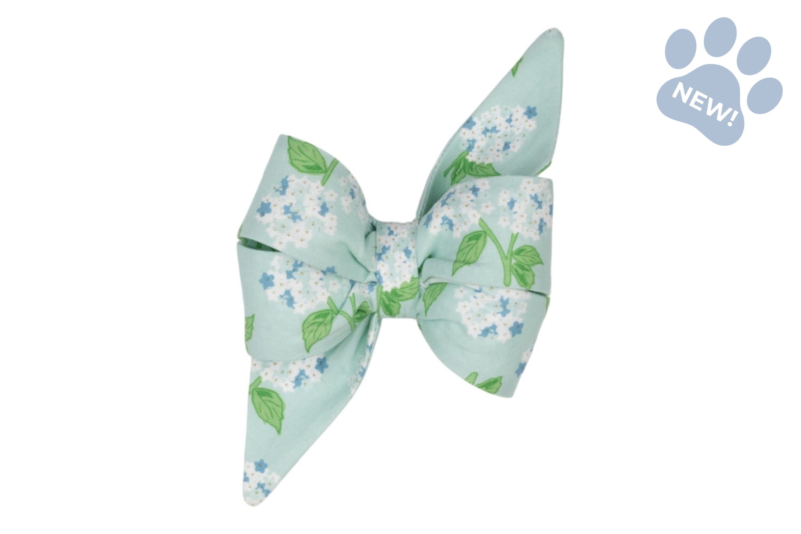 Hydrangea-print belle bow dog collar accessory featuring an oversized bow with white hydrangea blooms, blue floral accents, and green leaves on a soft mint blue background, finished with elegant pointed tails.