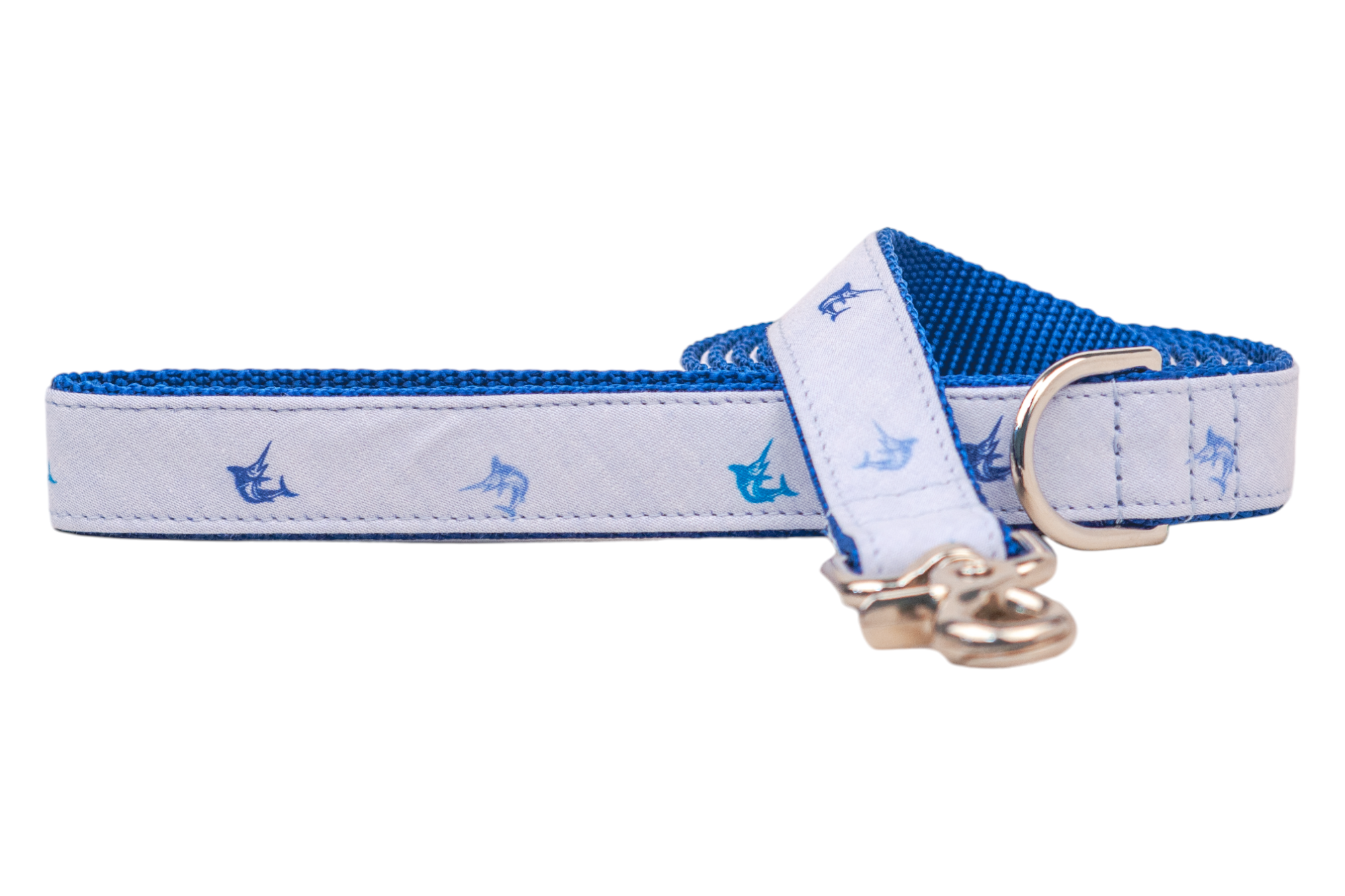 Nautical-inspired dog leash in light blue with blue marlin fish designs, backed with vibrant blue webbing. The design is complemented by silver accents for durability and style.