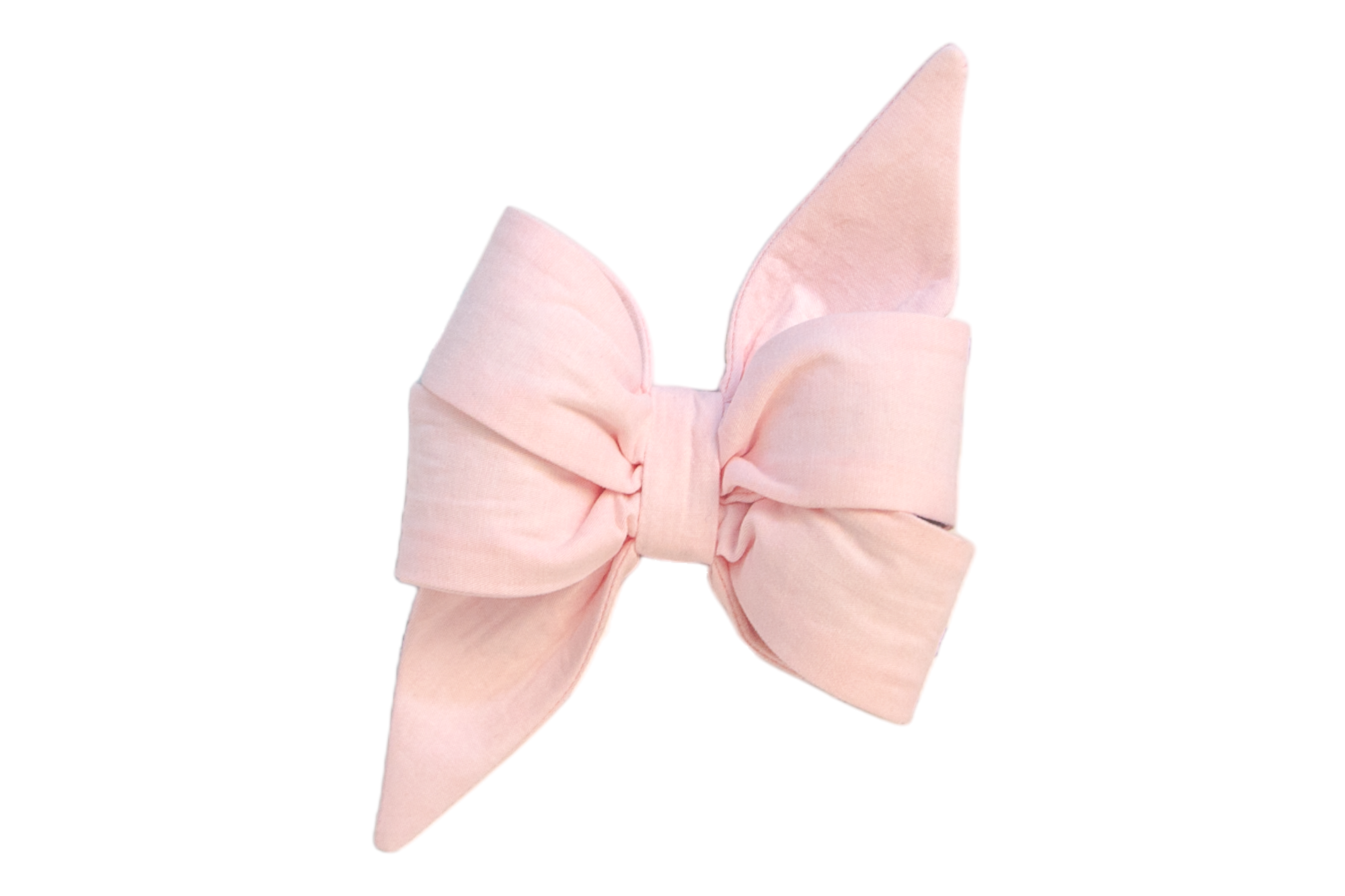 Soft pink linen girl dog belle bow with exaggerated bow loops and sleek, pointed edges. A stylish accessory crafted for pets, combining comfort and charm.