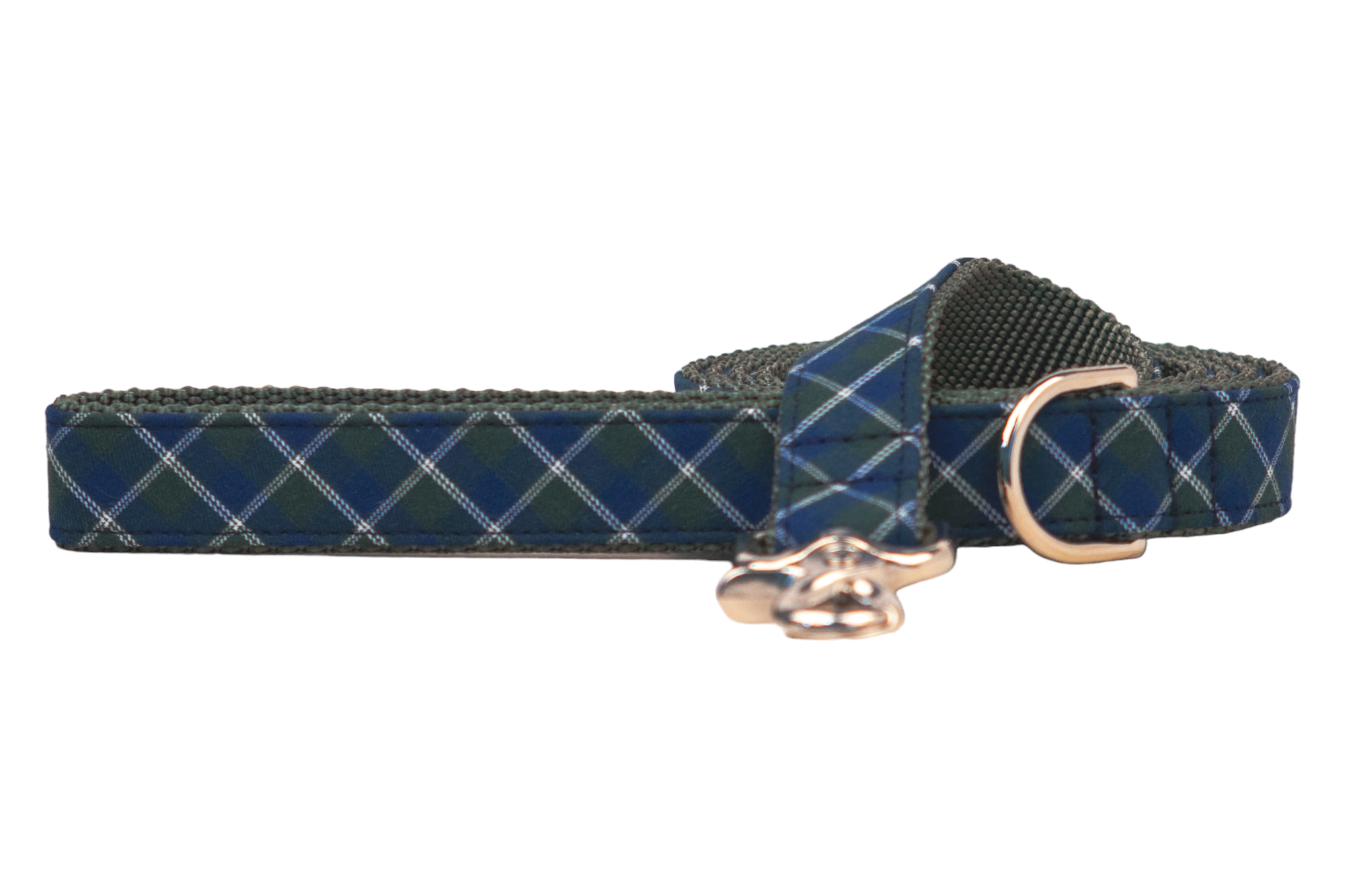 Close-up of a fabric dog leash in green and navy blue argyle plaid print, with green interior webbing, and metal hardware for attachment.