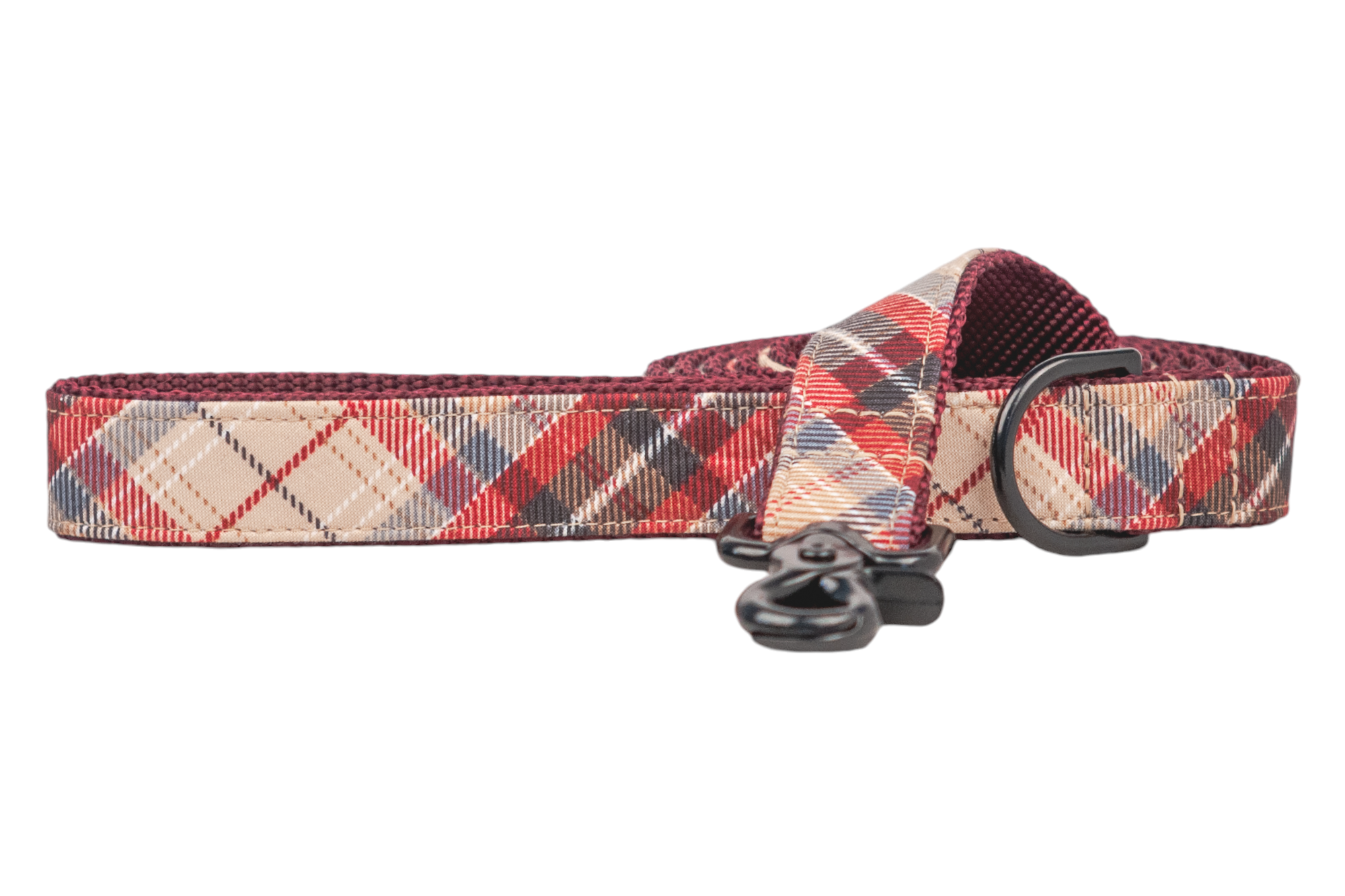 A handcrafted dog leash with a cozy plaid design. Includes metal hardware and reinforced stitching, backed with durable webbing for everyday use. Handmade in Charleston, SC.