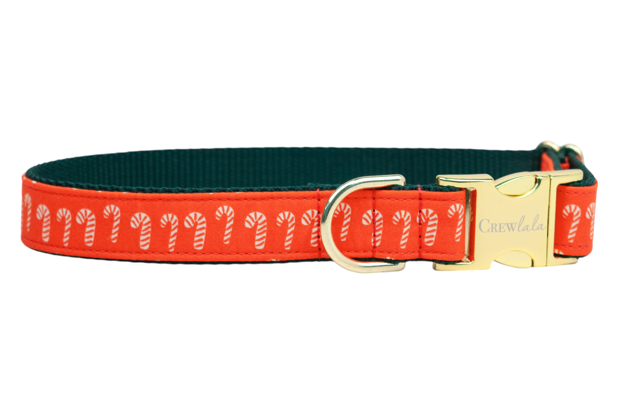 Holiday dog collar featuring red fabric printed with candy canes and reinforced with a dark inner lining. Metal components include a sleek buckle engraved with the brand name "Crewlala" and a D-ring, blending festive design with everyday practicality.
