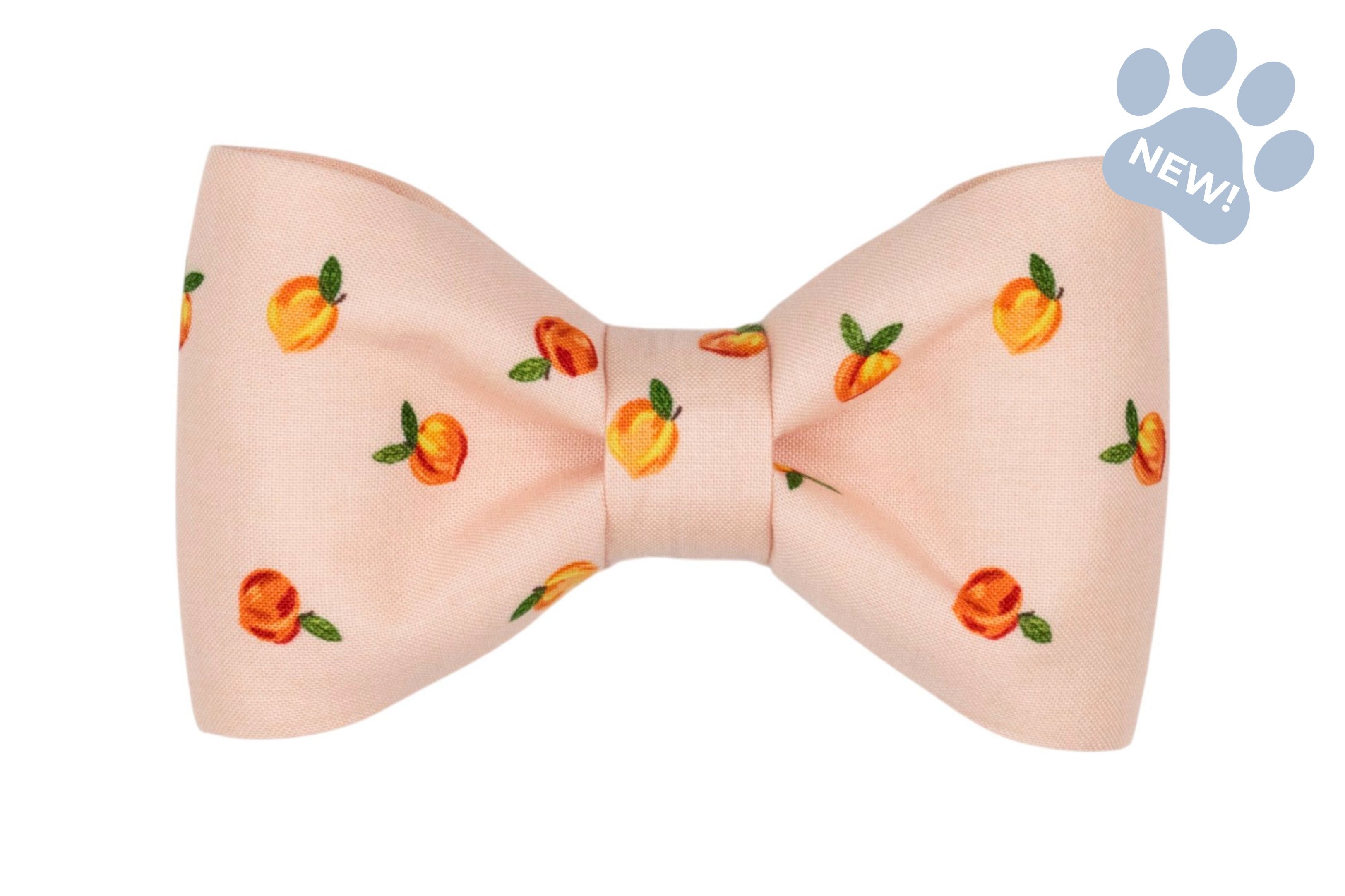 Peach-print dog bow tie featuring a classic bow shape on a blush pink background, decorated with small peach illustrations and green leaves.