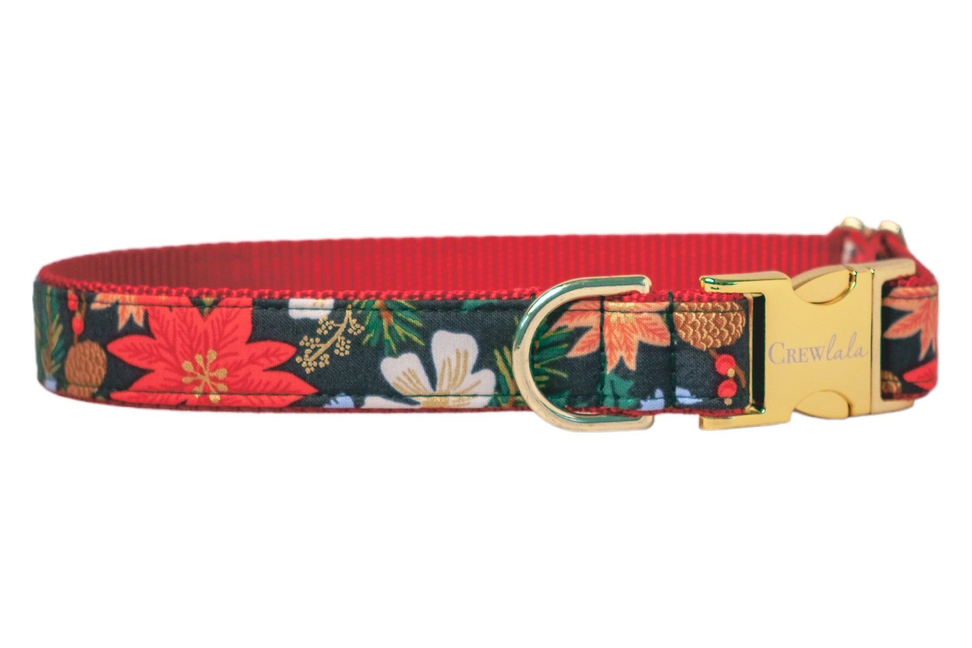 Christmas-inspired dog collar with a deep green background and bold floral design including poinsettias, flowers, pinecones, and green foliage. The collar features a contrasting nylon webbing underside and polished hardware, including a D-ring and a glossy side-release buckle etched with “Crew Lala.”