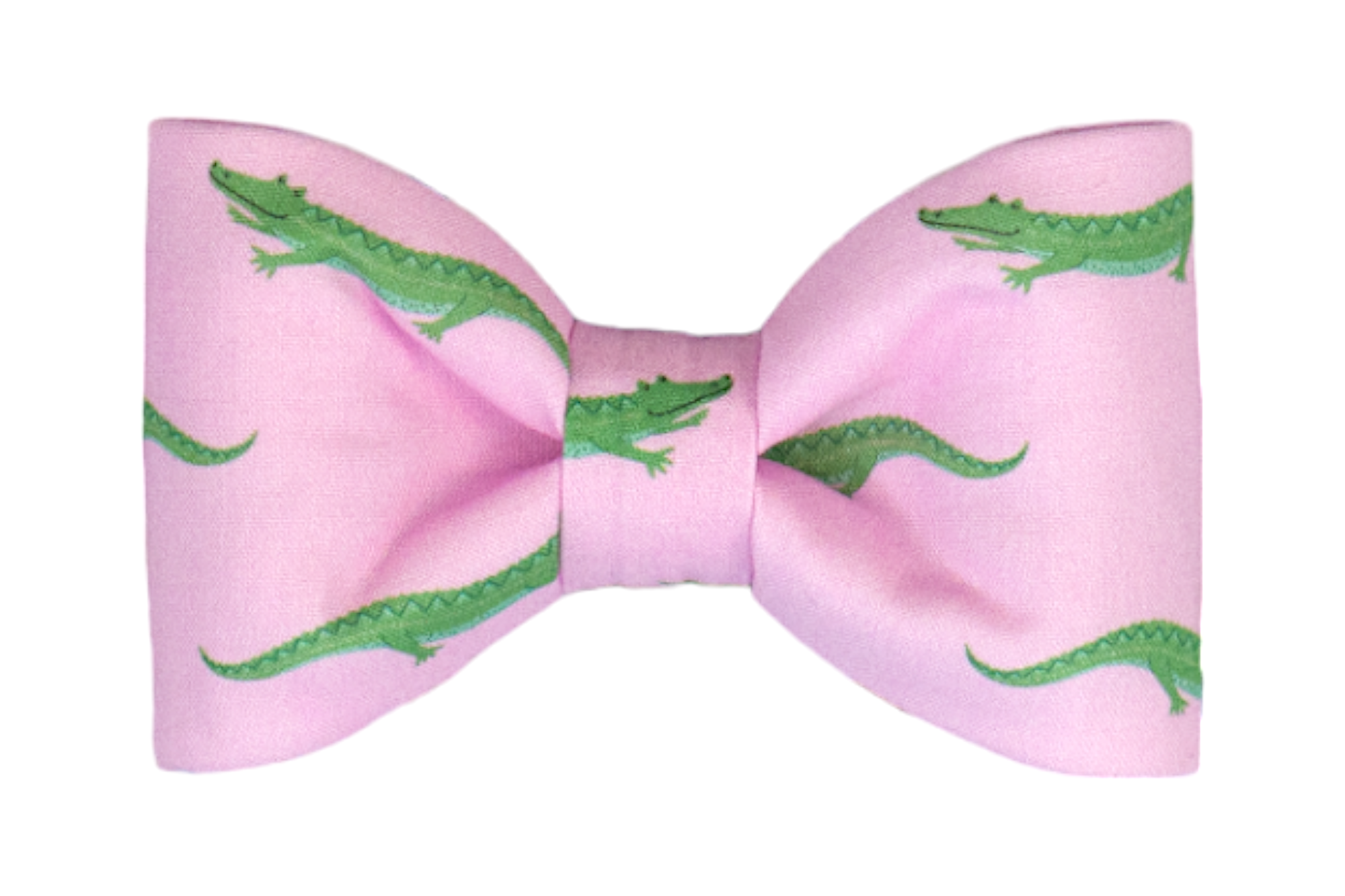 Pink fabric bow tie printed with a playful pattern of green crocodiles facing in various directions. The dog bow tie is neatly tied with symmetrical loops and a tightly wrapped center band.