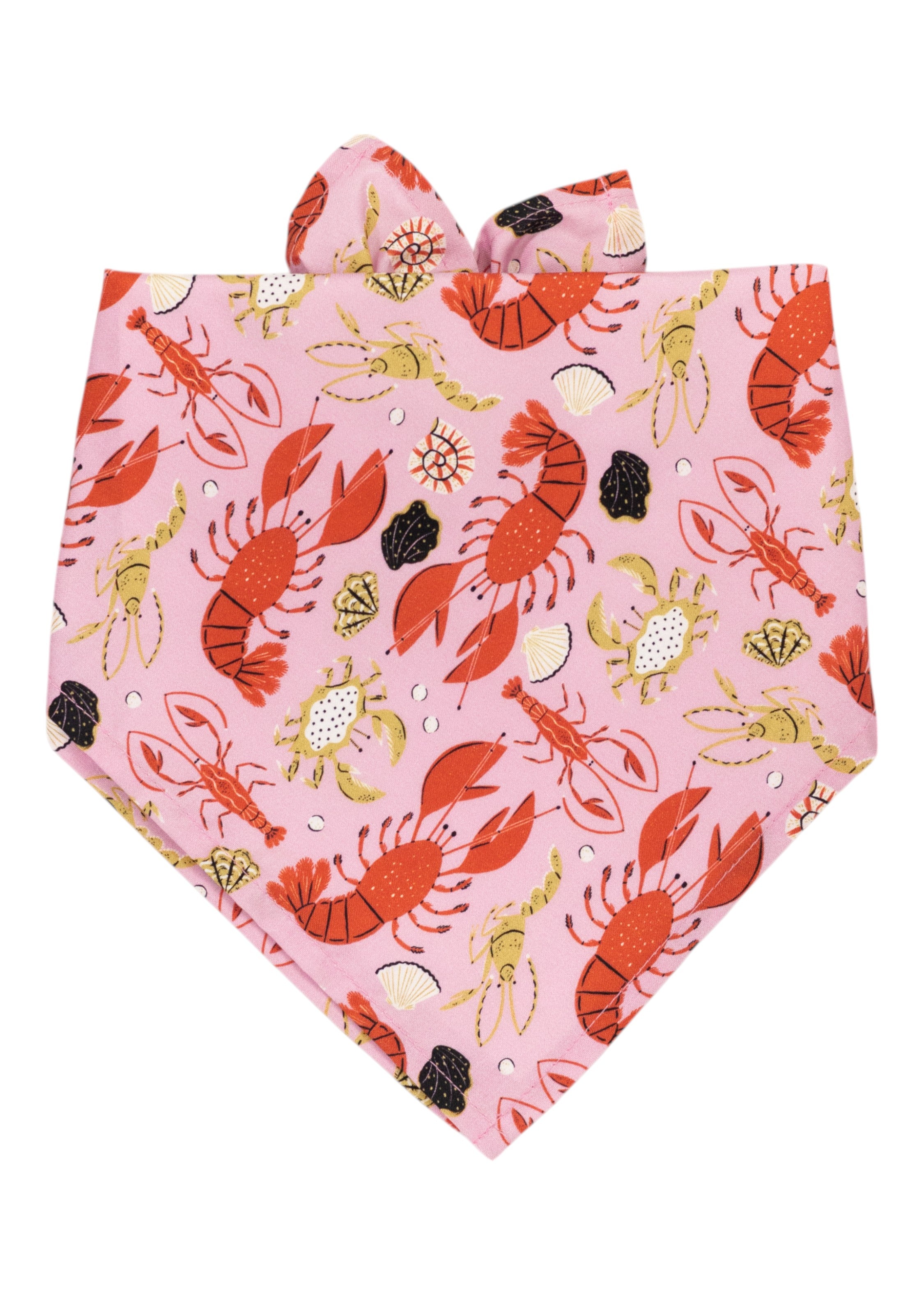 Pink dog bandana featuring a lively ocean-themed print with red lobsters, yellow crabs, shrimp, seashells, and black coral scattered throughout.