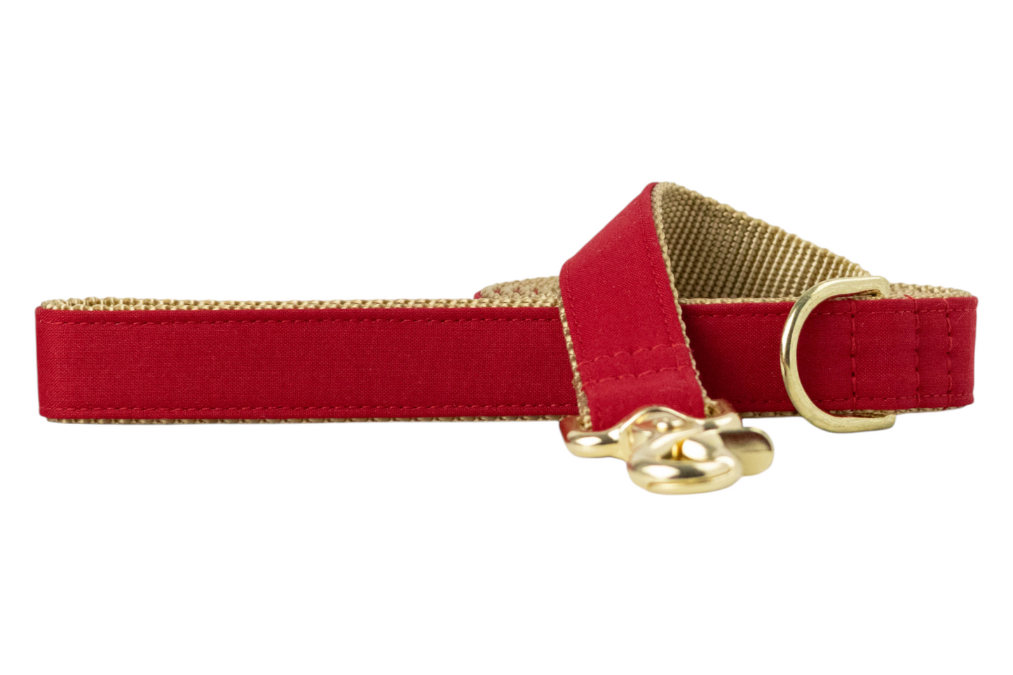 Elegant pet leash showcasing a smooth red fabric on the outside and a woven nylon backing, accented with luxe hardware, including a swivel clip and reinforced stitching near the handle and clasp.