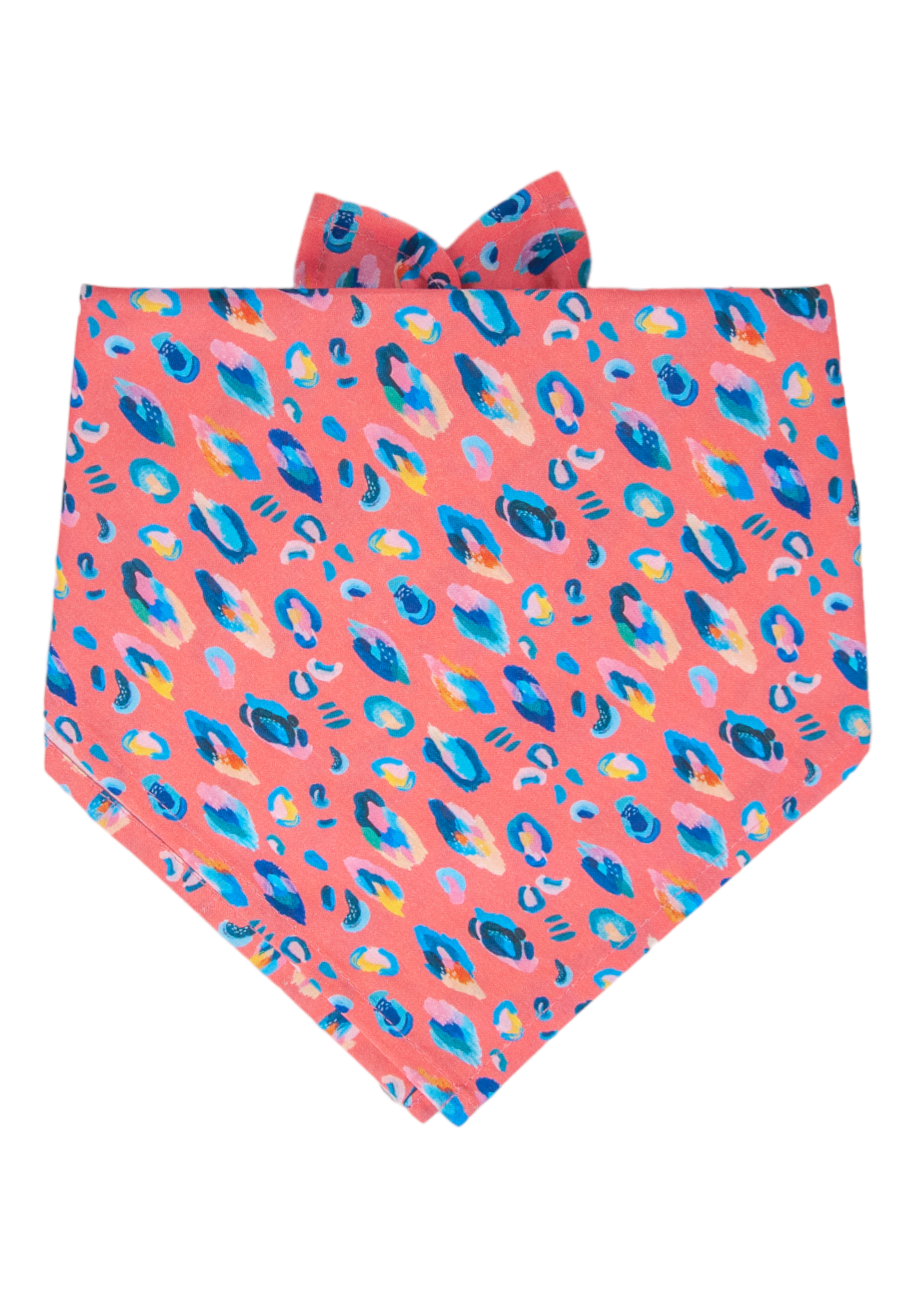 A bold tie-on dog bandana with a coral pink base and painterly leopard spots in — the ultimate statement accessory.