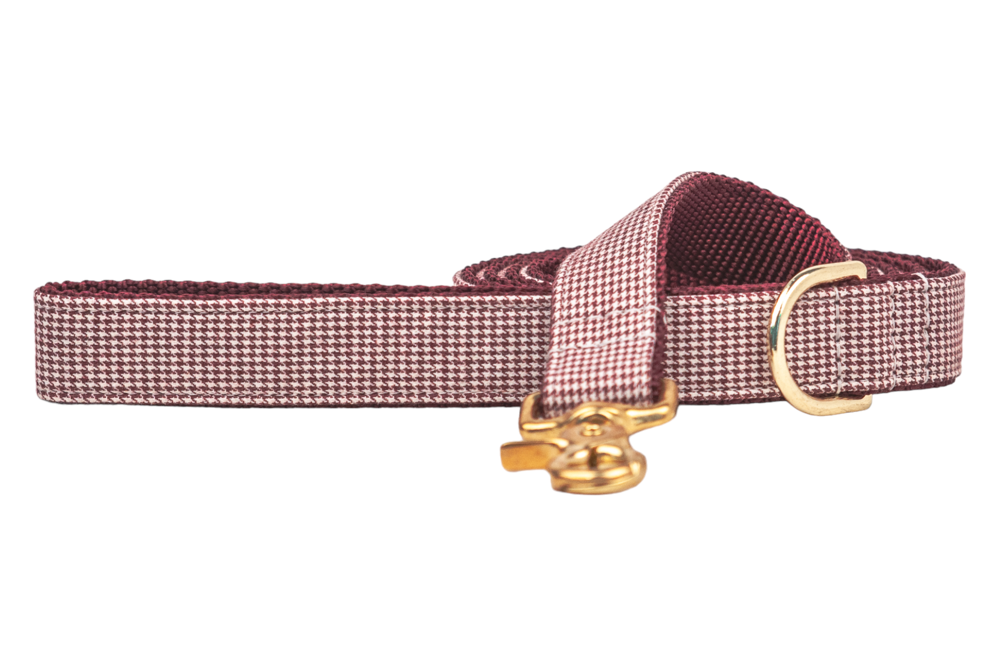 Burgundy houndstooth dog leash with a subtle textured weave, metal hardware, and reinforced stitching, coiled with the clasp and D-ring prominently displayed.