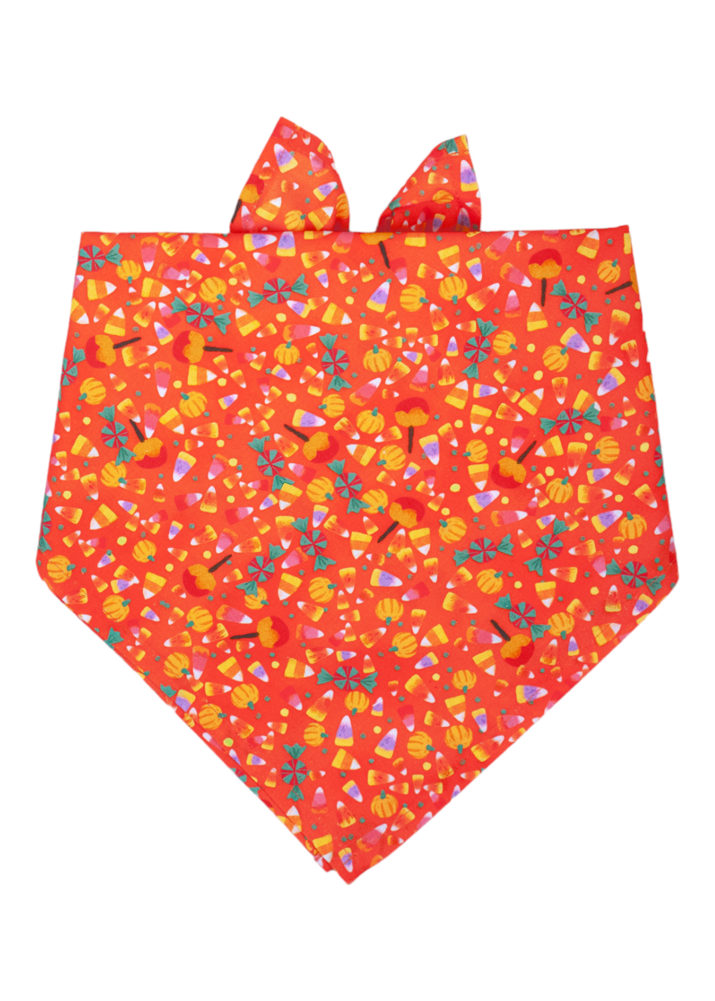 Tie-on dog bandana with a vibrant orange background, decorated with an all-over print of Halloween candies and icons including candy corn, pumpkins, peppermint swirls, and caramel apples. The fabric is lightweight and neatly stitched, with top corners designed for secure tying around a dog's neck.