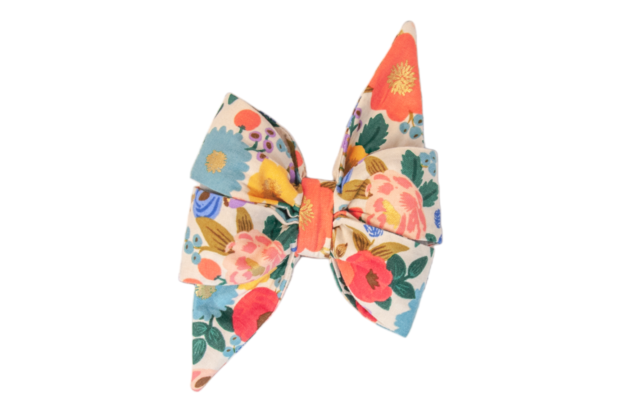 Floral dog bow with an elegant, oversized silhouette featuring tall pointed tails. The cream background is covered in a bold print of garden blooms and leafy accents and shimmering details.