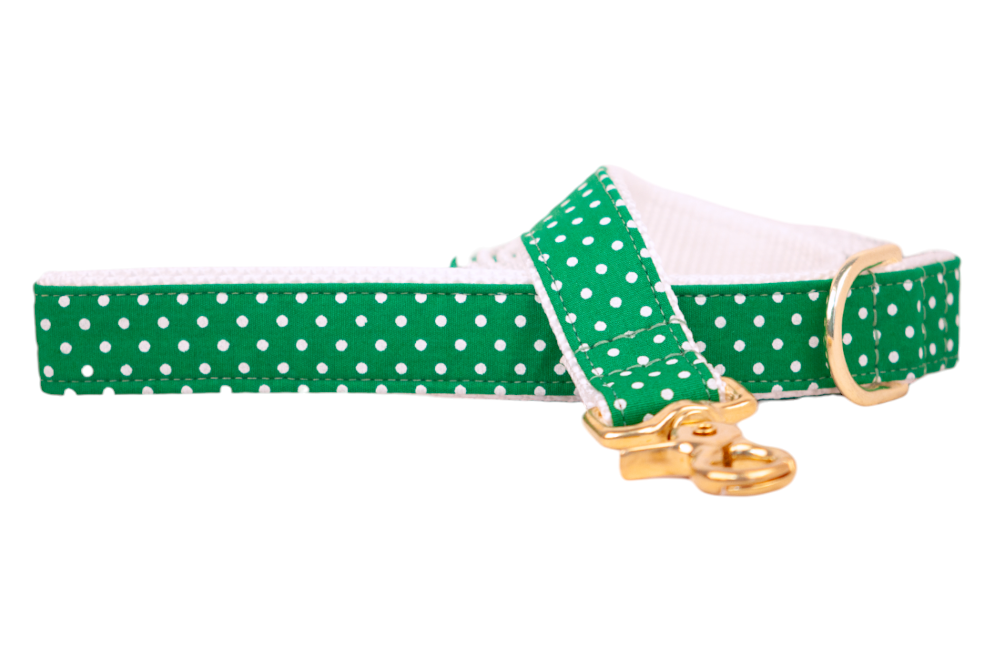 A festive green leash for dogs, decorated with small white polka dots and reinforced with precise stitching. The leash includes a shiny gold metal clasp and a coordinating D-ring, with white webbing lining the underside for contrast and comfort.