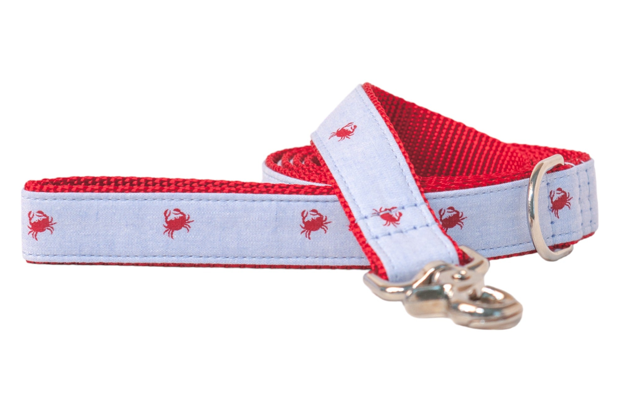 A light blue dog leash with a playful red crab pattern, featuring a bright red woven nylon underside. The leash includes silver-toned hardware, such as a metal D-ring and a polished clasp.