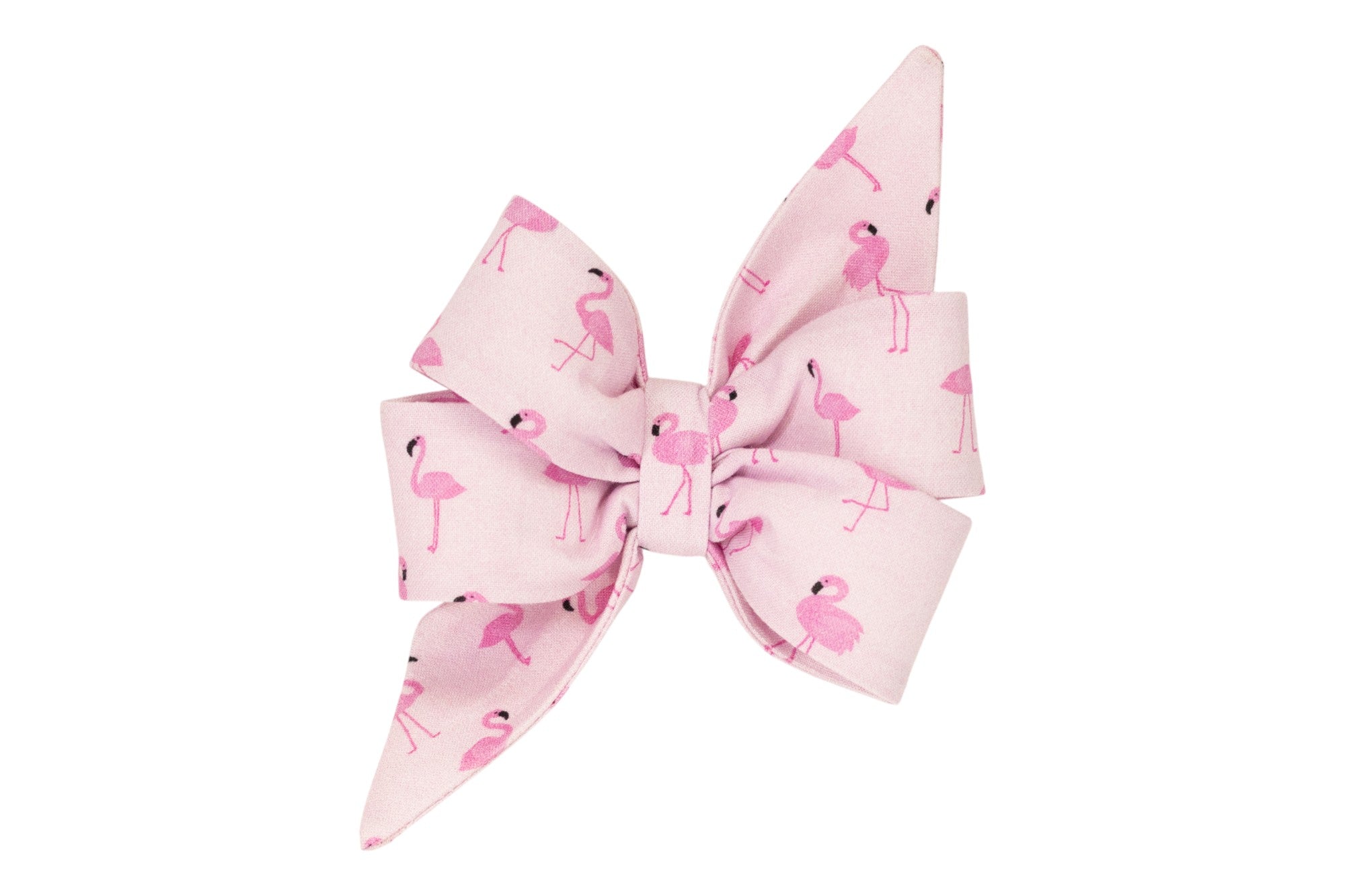 Close-up of a pastel pink decorative girl dog belle bow adorned with pink flamingo illustrations, featuring elegant pointed ends and crisp folds for a structured look.