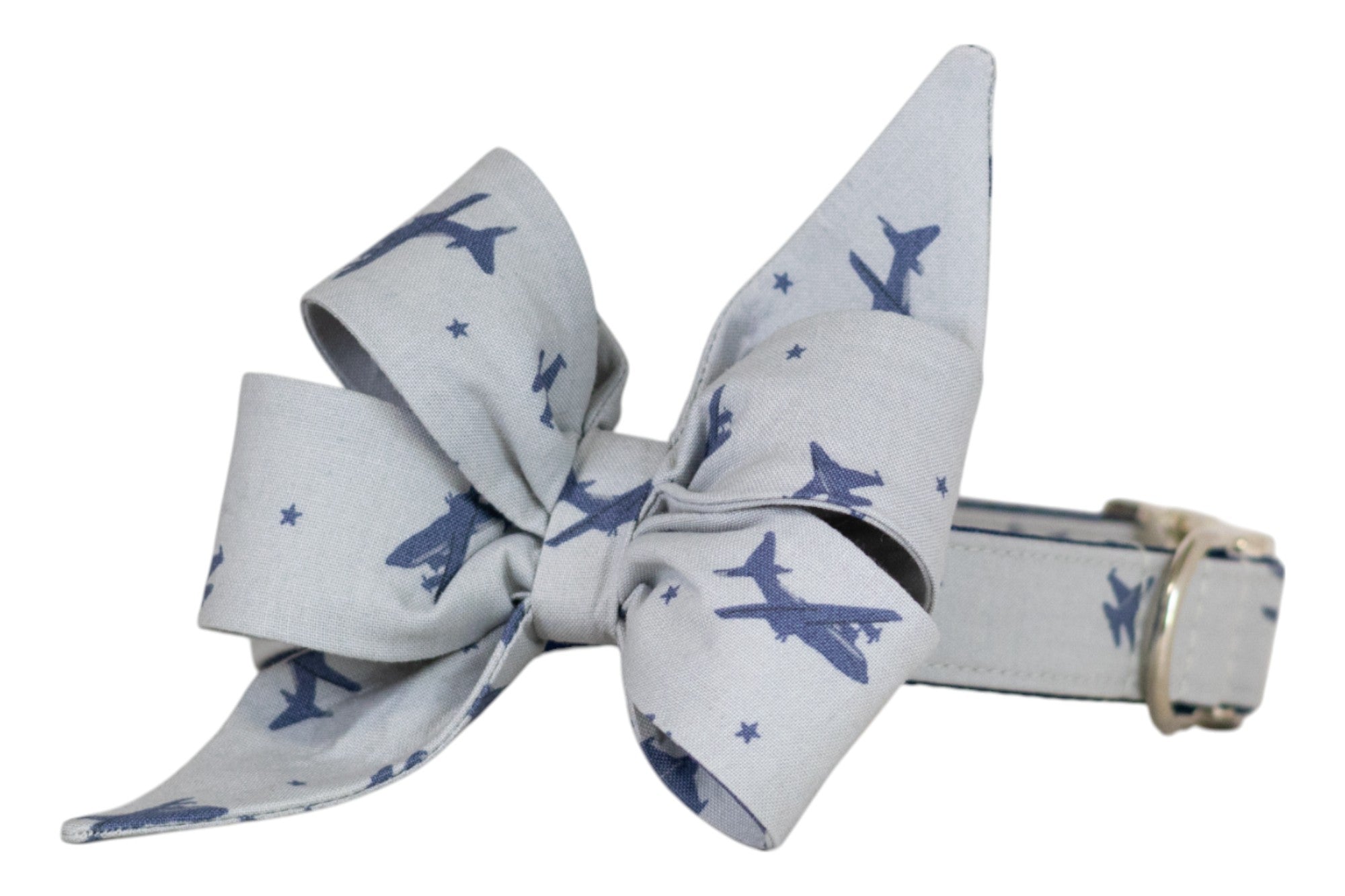Aviation-themed gray girl dog belle bow featuring scattered navy blue jet silhouettes and small stars, secured to a matching dog collar with silver hardware.