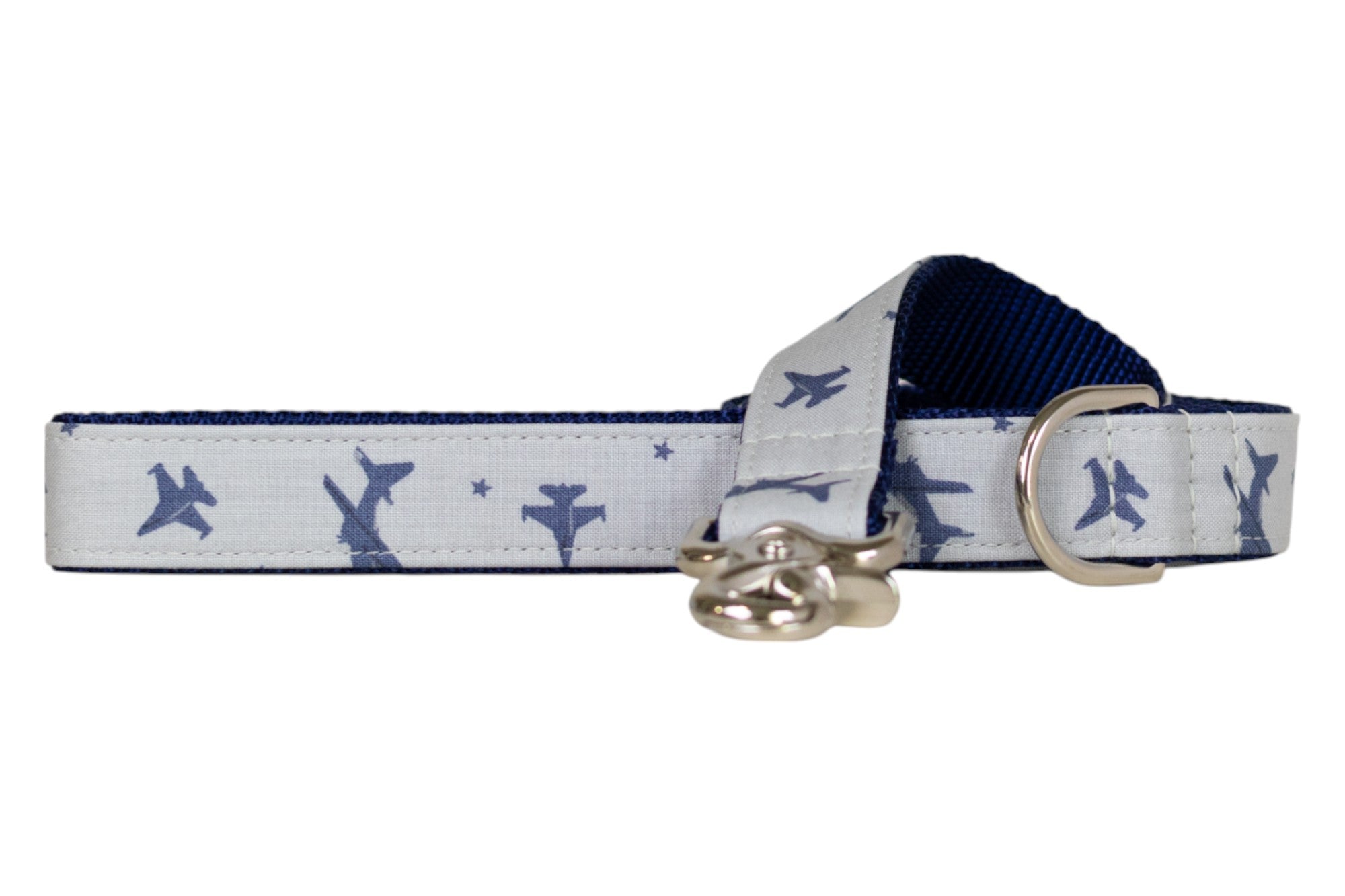 Aviation-themed gray dog leash with a repeating design of blue fighter jets and stars, complemented by a navy blue underside, a silver D-ring, and a shiny metal clip for attachment.