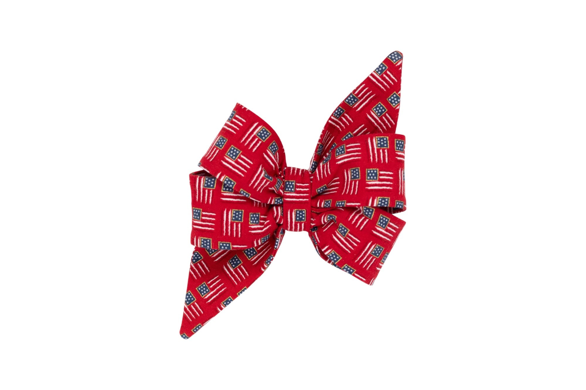 Patriotic girl dog belle bow featuring a vibrant red background with scattered American flag motifs—perfect for July 4th celebrations.