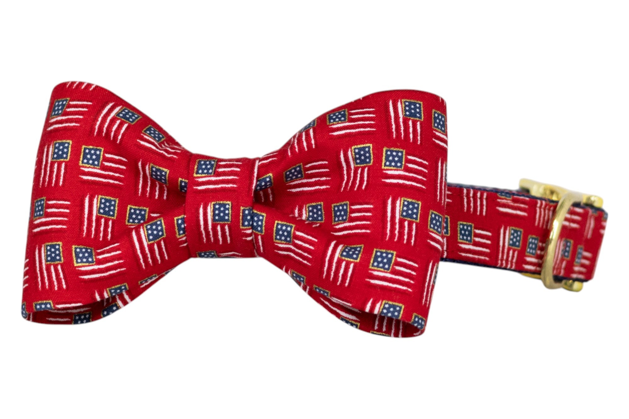 Patriotic-themed red bow tie decorated with miniature American flag designs throughout, paired with a matching collar and a gold buckle.