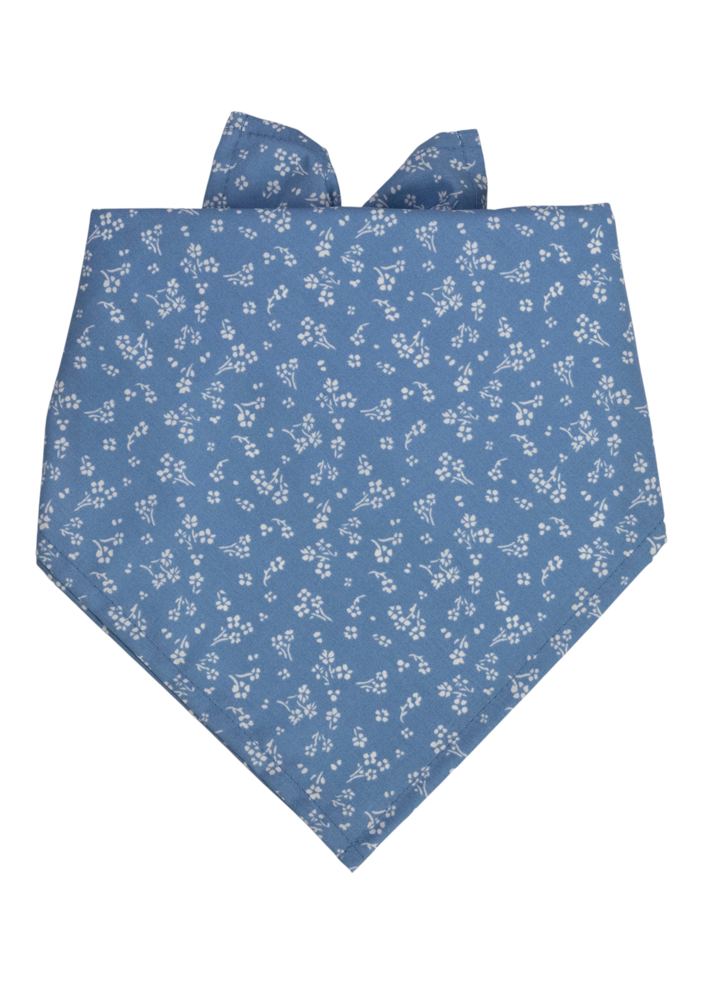 A blue dog bandana with a delicate floral print, folded in a triangle shape and tied at the top.