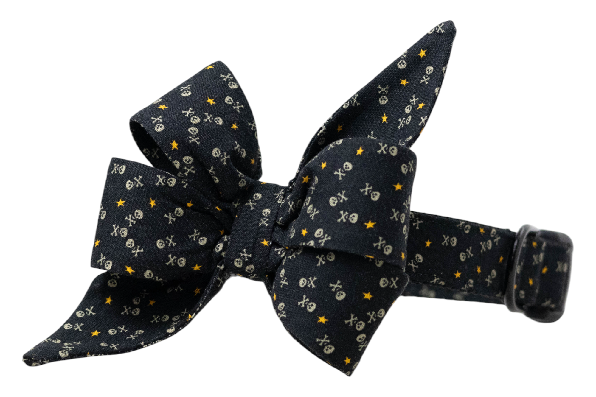 Decorative dog belle bow collar in black, covered in tiny skull motifs and scattered stars, styled with layered loops and pointed ends for a dramatic look, secured to an adjustable matching collar.