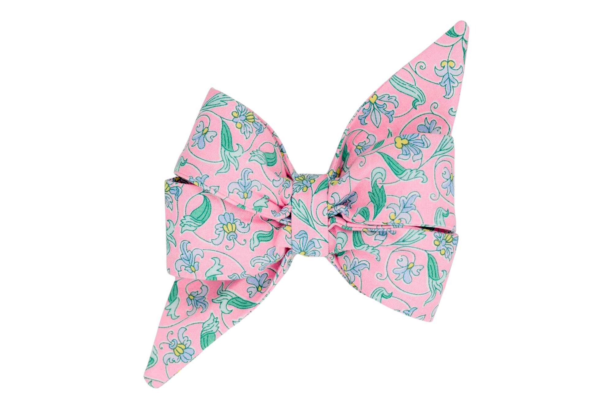 A handmade girl dog belle bow with an elegant vintage-inspired floral pattern, featuring delicate green vines and pastel blue flowers on a soft pink background. A perfect Spring pet accessory.