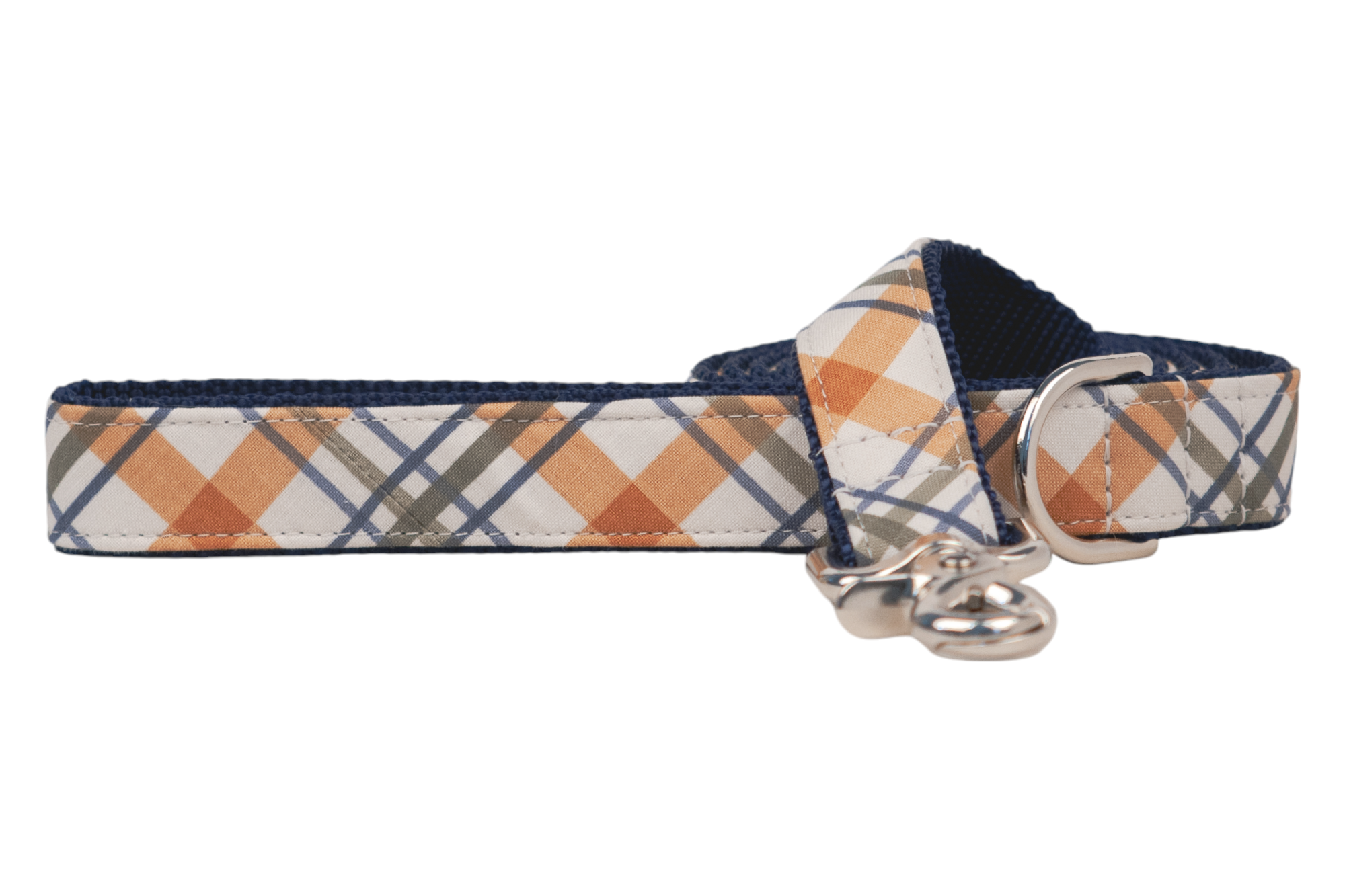 Plaid dog leash in warm fall shades, finished with a strong webbing interior lining. A swivel clasp is attached at the end, and a matching D-ring sits just below the handle for added functionality.