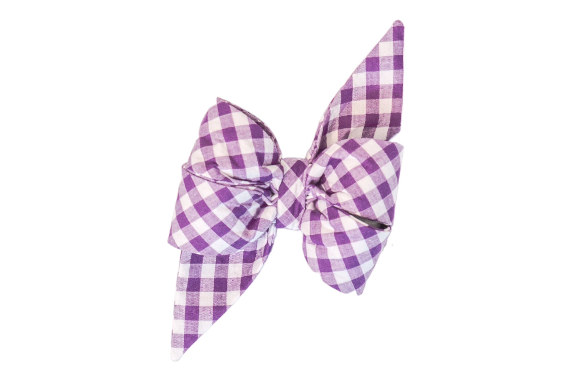 Dog belle bow made from fabric with a purple picnic plaid pattern. The belle bow features two large loops and two pointed tails, giving it a full and feminine appearance. It is neatly cinched in the center and the perfect addition to your pup's fall wardrobe.