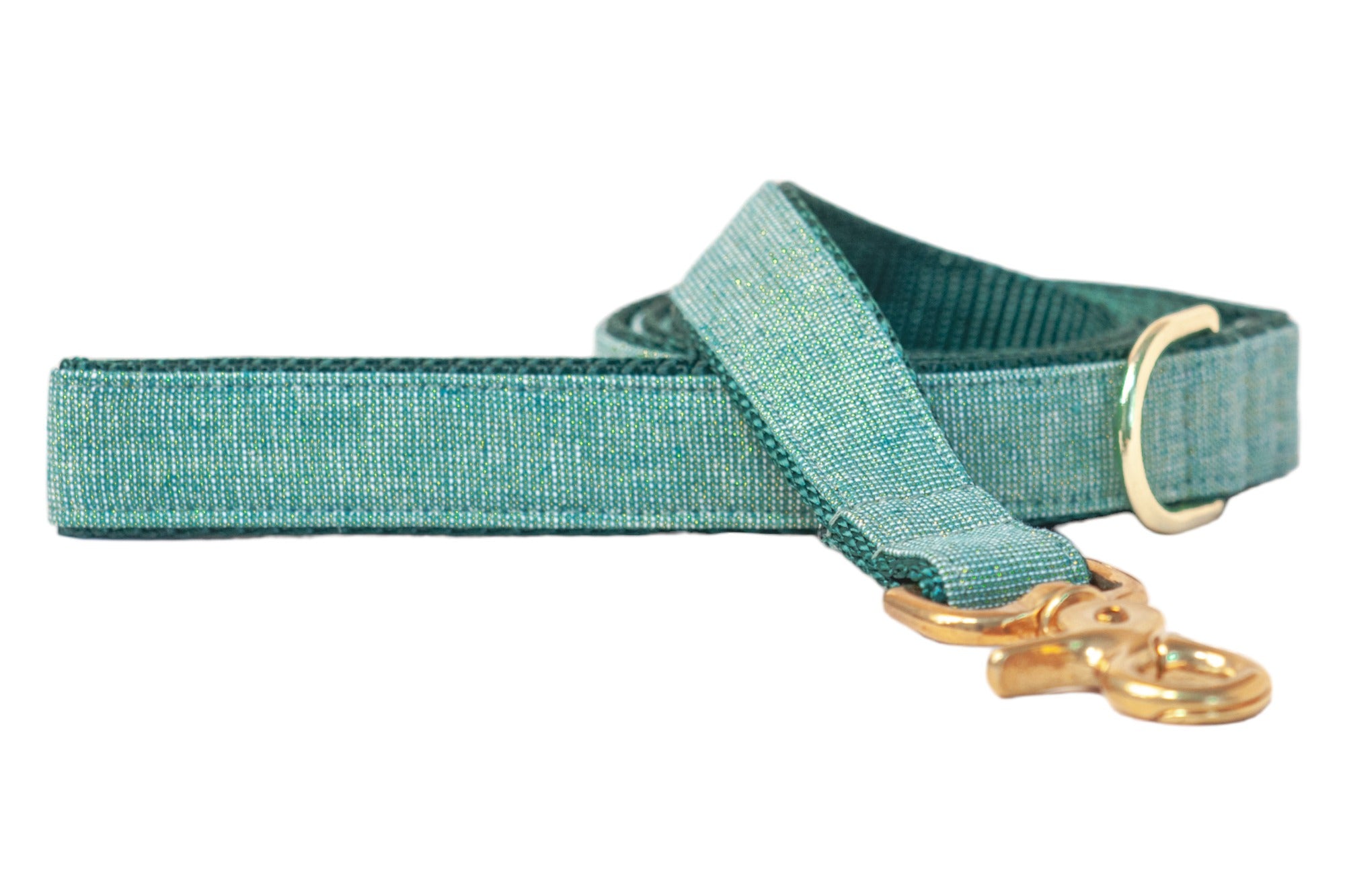 A stylish dog leash made from a woven green fabric with a subtle glittery sheen, neatly coiled and partially extended on a clean white background. The leash features polished metal hardware, including a D-ring near the handle and a sturdy swivel snap hook.