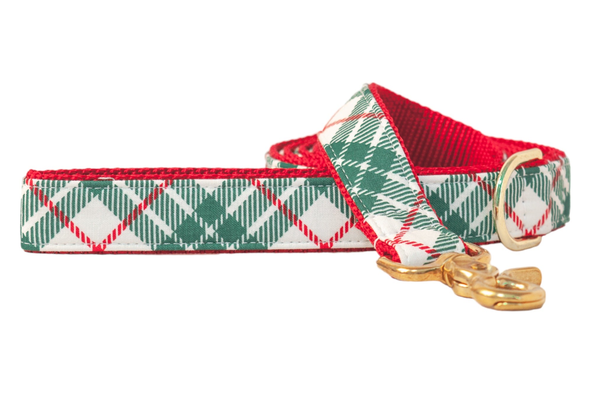 Christmas-themed dog leash with a green plaid print on a light fabric background, paired with vibrant webbing on the underside. The leash is partially coiled and finished with shiny hardware, including a D-ring near the handle and a swivel snap hook.