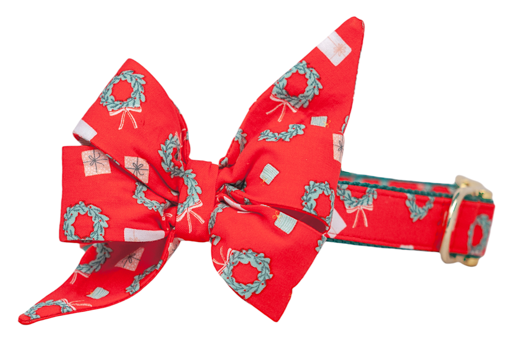 Holiday-themed dog collar made from red fabric covered in wreaths and tiny gift illustrations. A large, matching decorative belle bow with dramatic, structured points is centered on the collar, which is finished with a shiny buckle and D-ring.