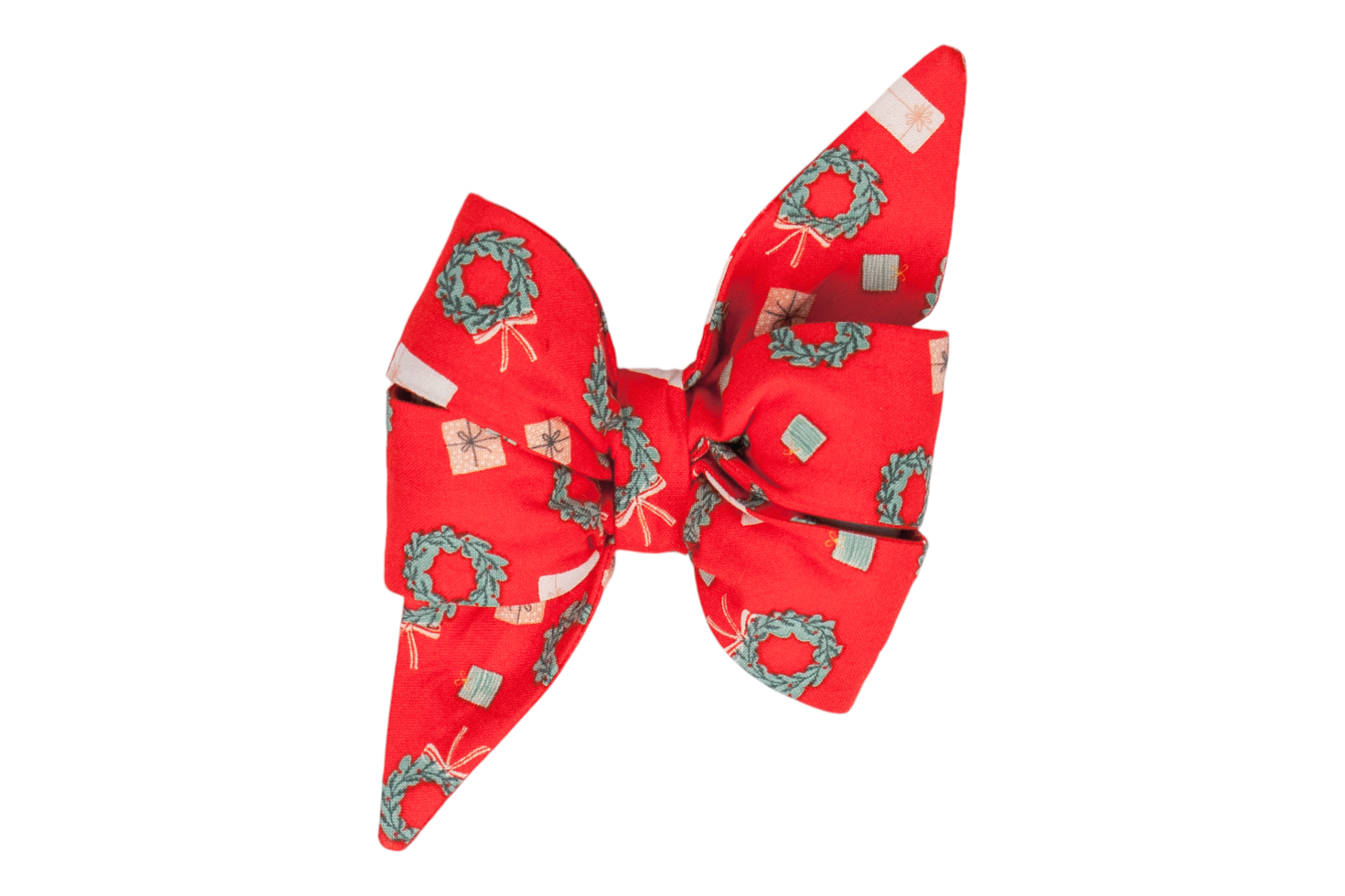 Christmas-themed decorative belle bow made from red fabric covered in miniature wreaths and various gift illustrations. The belle bow has a gathered center, puffed loops, and sharply angled tails, giving it an elegant and feminine, yet playful silhouette.