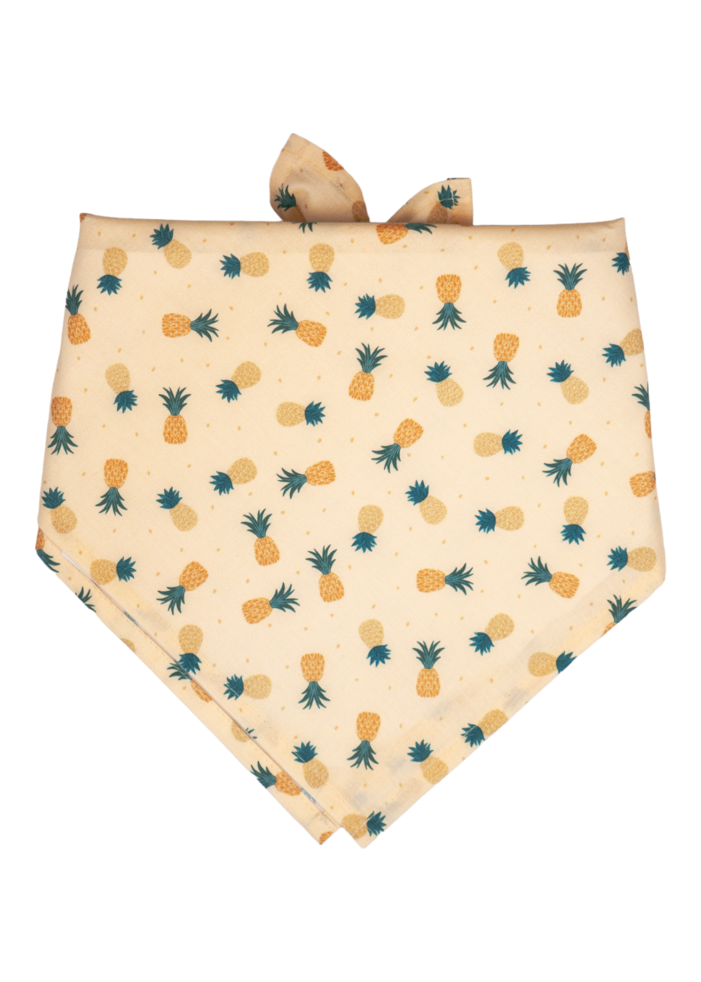 A soft yellow dog bandana decorated with a tropical pineapple pattern in muted yellow and orange shades, with dark green crowns.