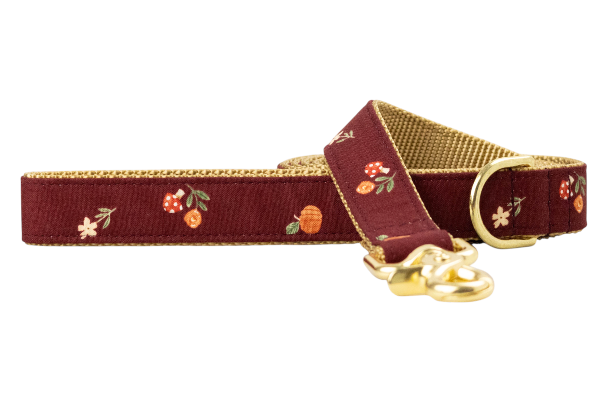 Burgundy dog leash adorned with whimsical fall illustrations such as mushrooms, pumpkins, and florals, complemented by nylon lining and metal hardware.