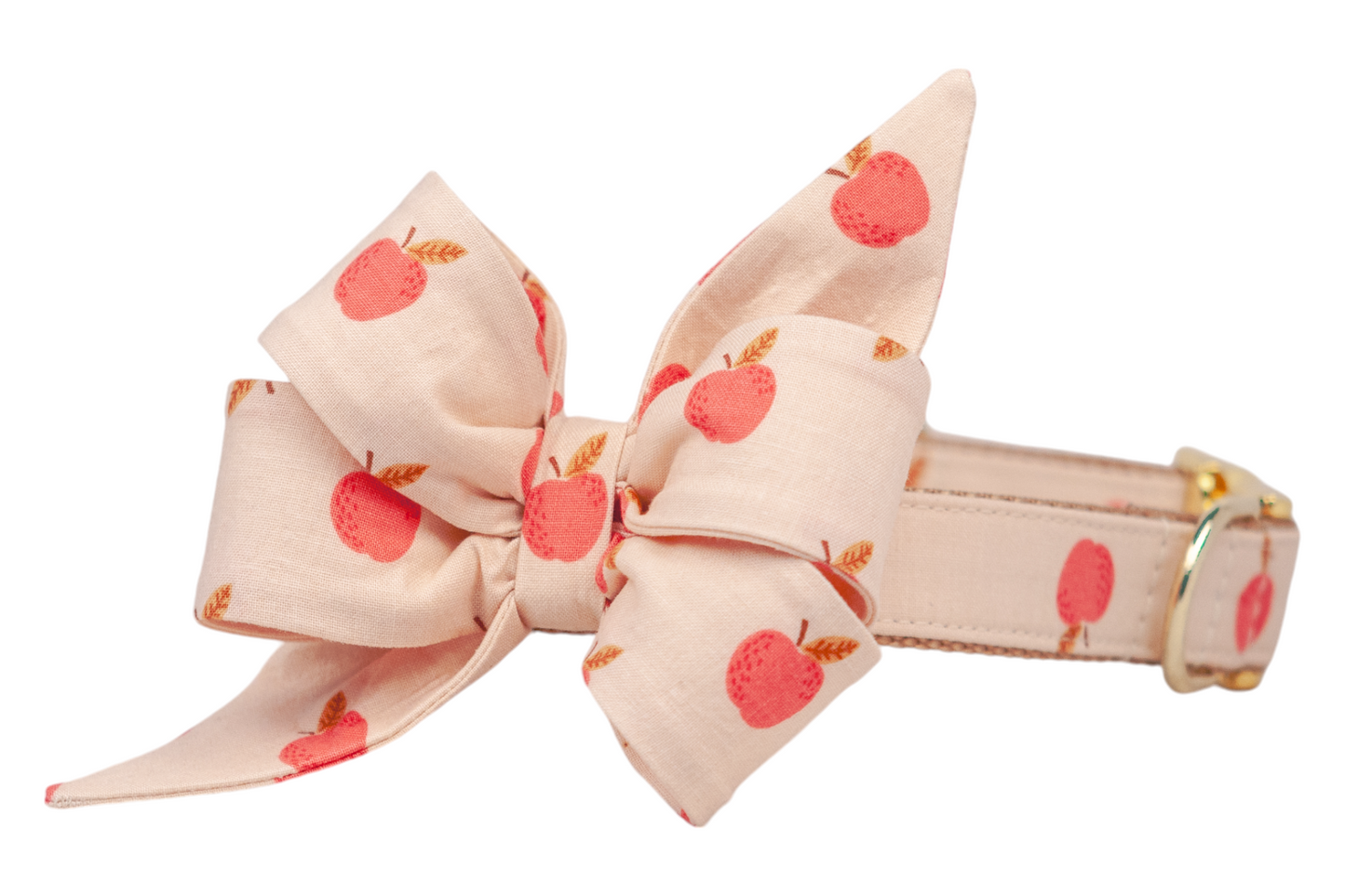A light beige dog collar with a matching attached feminine belle bow, decorated with red apples and leaves, finished with metal hardware. Handmade in Charleston, SC.