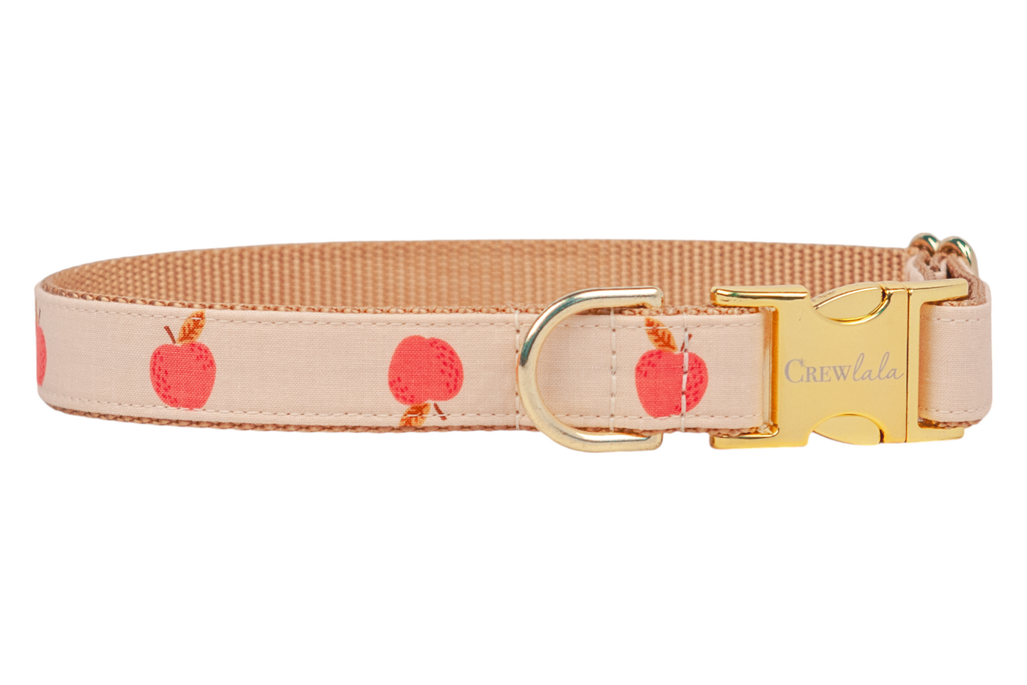 A beige dog collar with a repeating red apple pattern and metal hardware, including an engraved “Crewlala” side-release buckle and a matching D-ring. Backed with tan woven webbing for strength. Handmade in Charleston, SC.