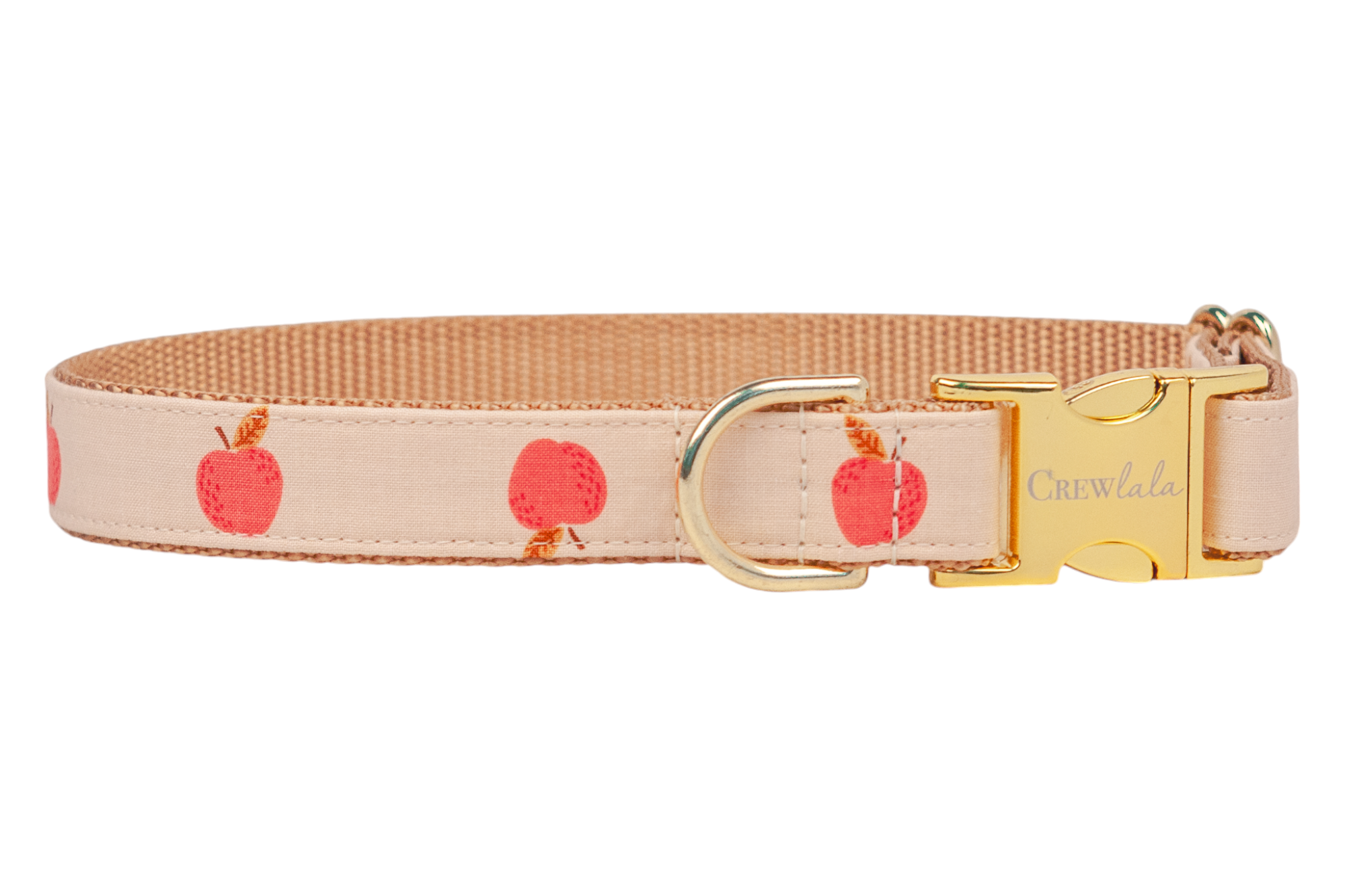 A beige dog collar with a repeating red apple pattern and metal hardware, including an engraved âCrewlalaâ side-release buckle and a matching D-ring. Backed with tan woven webbing for strength. Handmade in Charleston, SC.