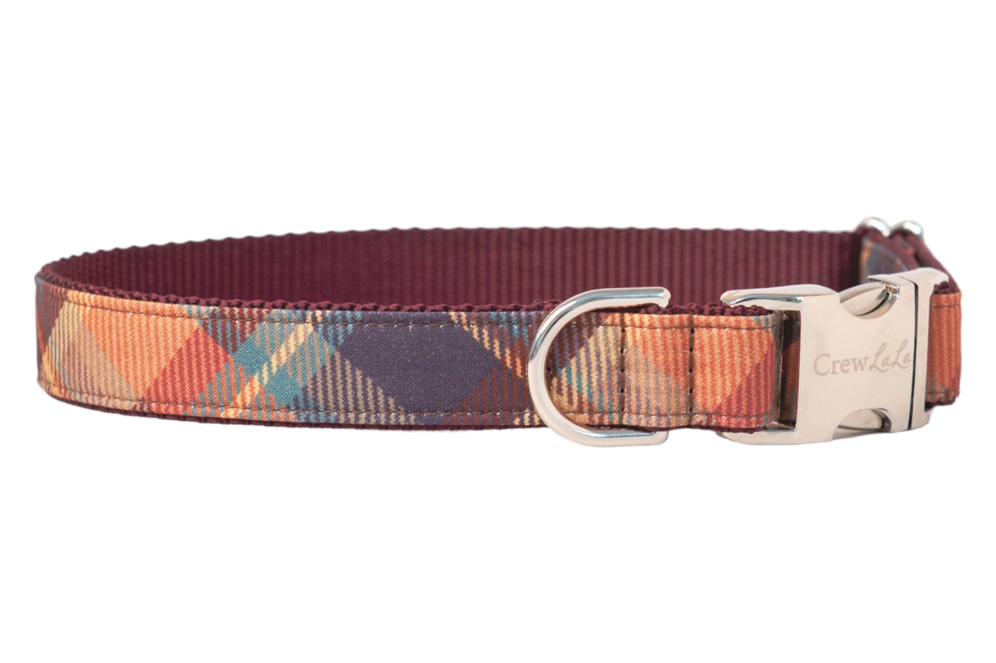 Plaid-patterned dog collar in warm, earthy tones with a nylon lining, metal hardware, and the “Crew LaLa” logo engraved on the buckle.