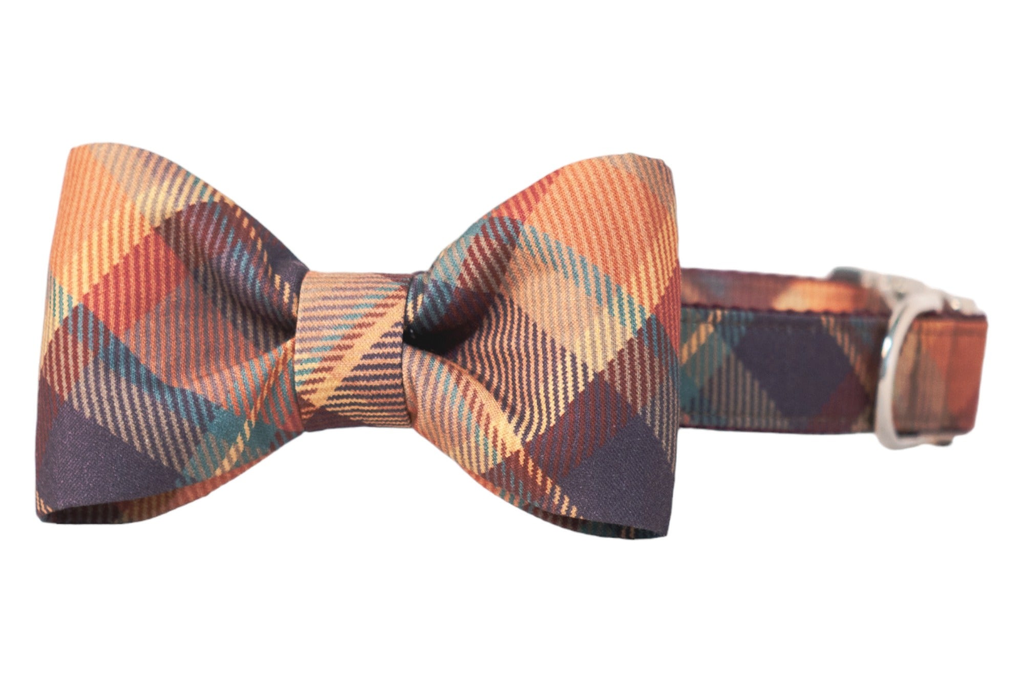 Fashionable dog collar with an attached bow tie, both crafted from the same patterned fabric. The pattern showcases a diagonal plaid print in earthy tones—perfect for a fall stroll. A shiny buckle is visible on the strap for secure fastening.