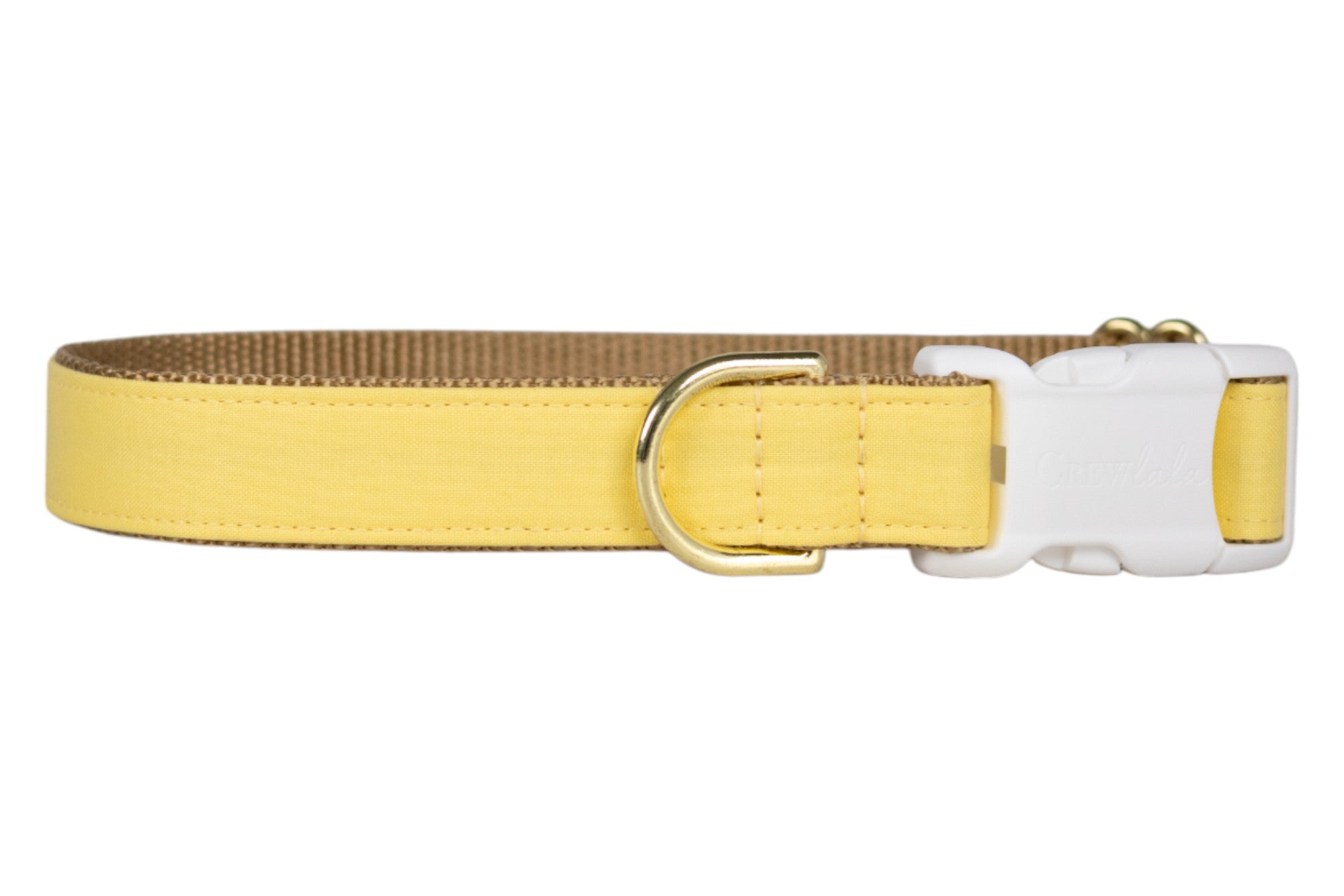 Adjustable dog collar in a cheerful solid yellow fabric, paired with nylon webbing for durability. Finished with a white buckle engraved with the “Crew Lala” logo and a metal D-ring for leash attachment. A bright and simple everyday accessory.