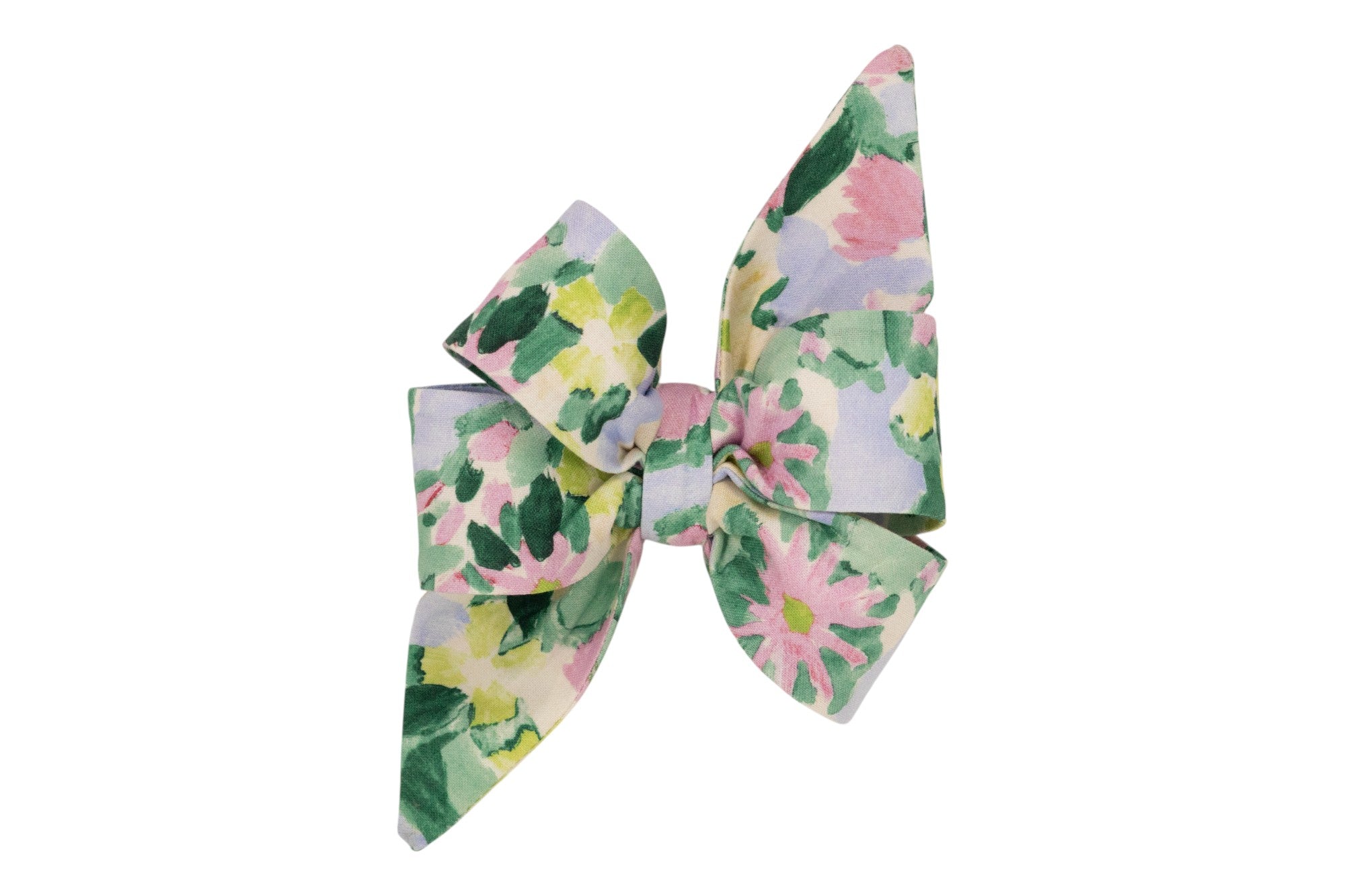 A decorative fabric dog belle bow with pointed tails, featuring a watercolor-style floral print in pink, yellow, green, and lavender tones.
